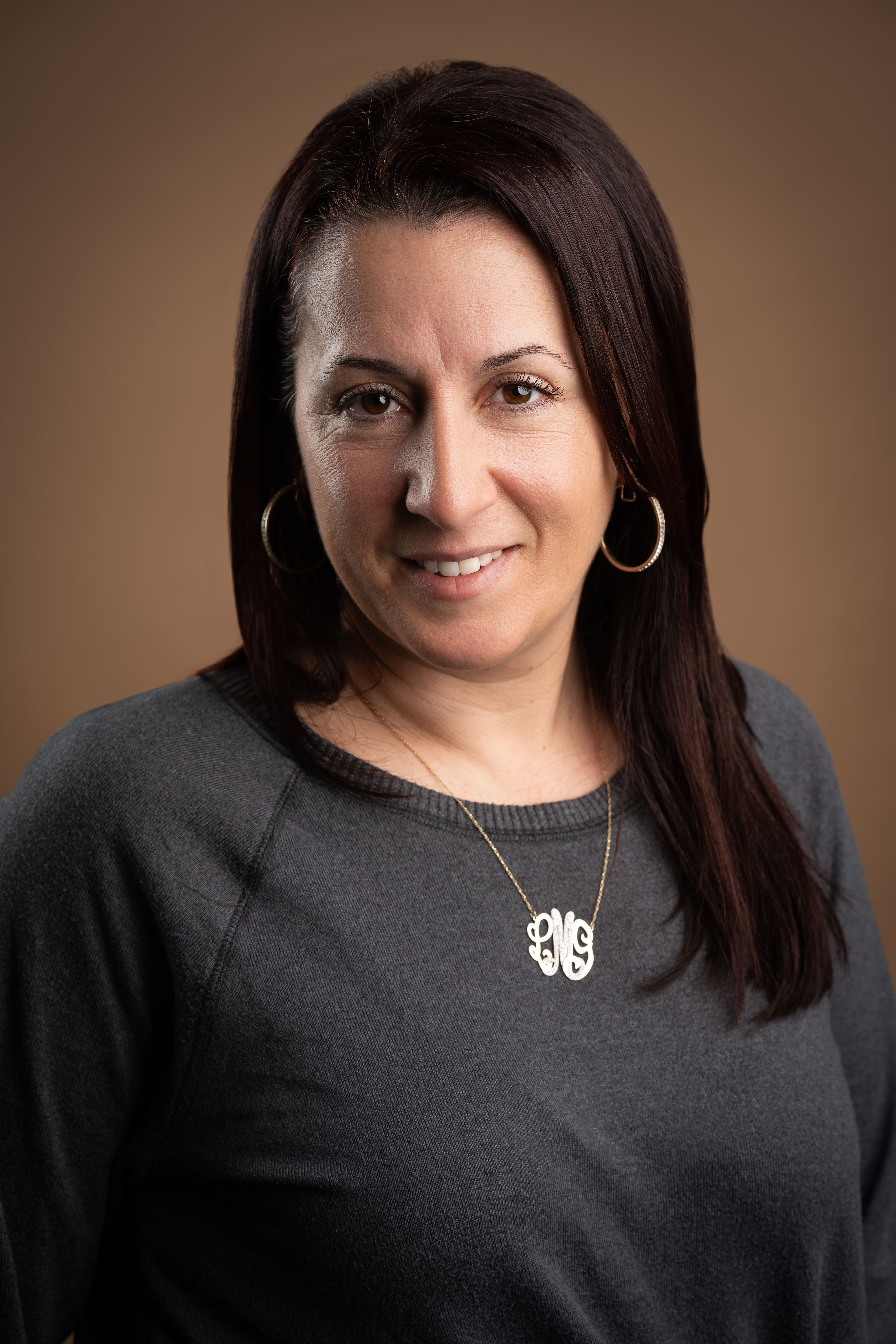 Staff portrait of M. Marciano smiling in professional headshot
