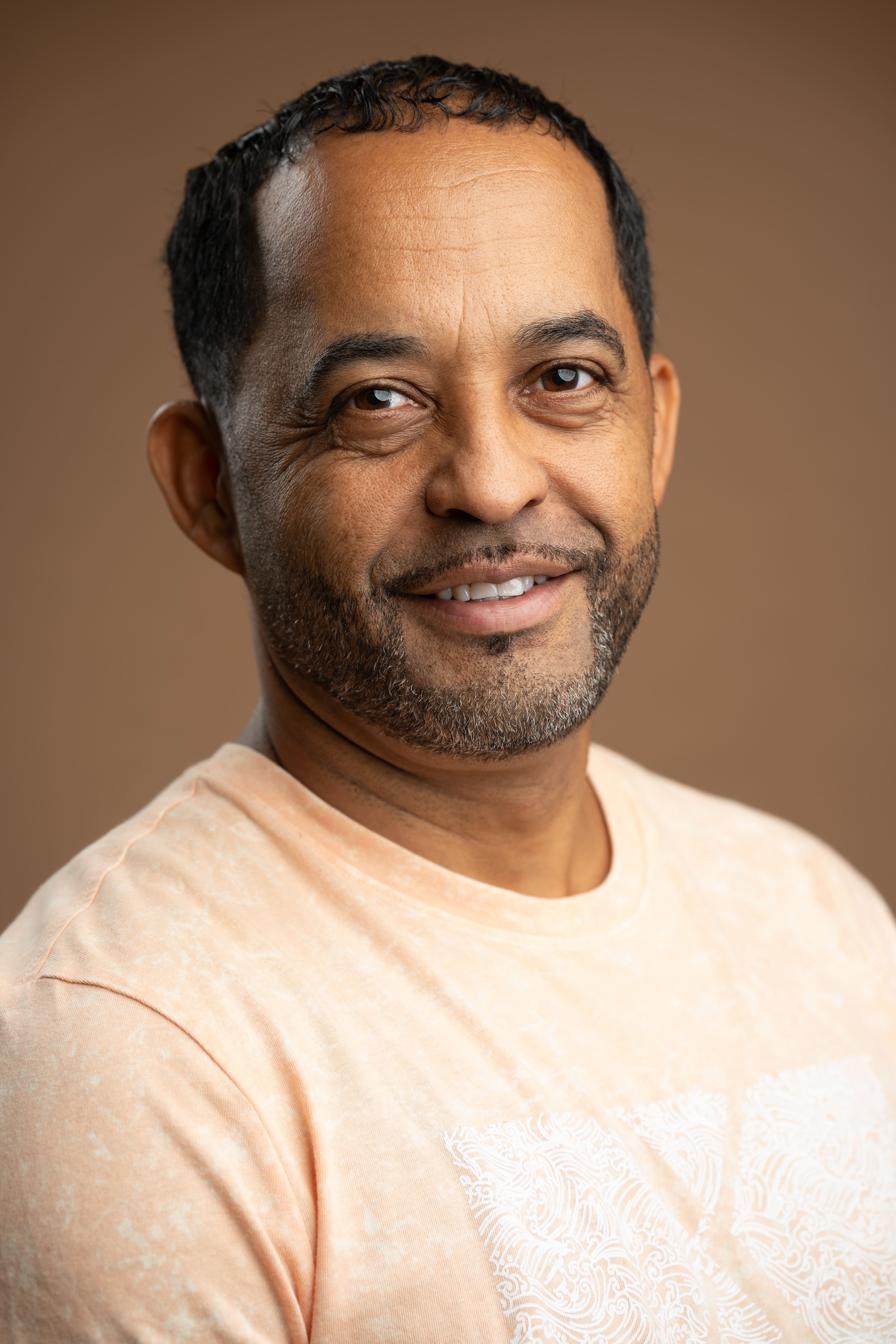 Juan smiling in a professional staff headshot photo