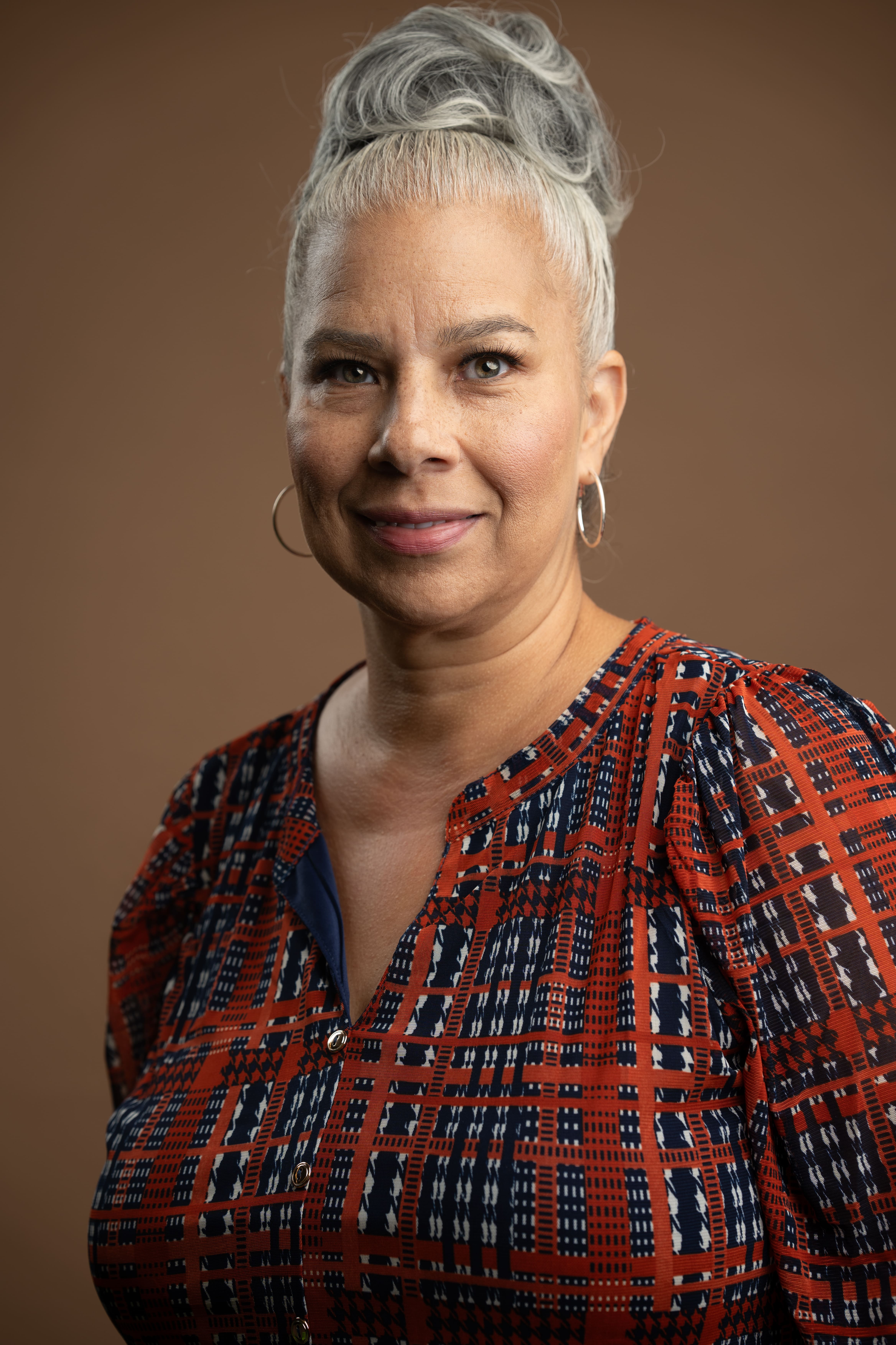 Staff portrait of Claribel Rodriguez smiling in patterned blouse