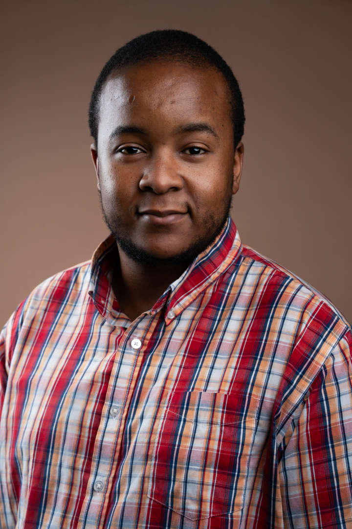 Mr. Ongama staff portrait photo smiling at camera