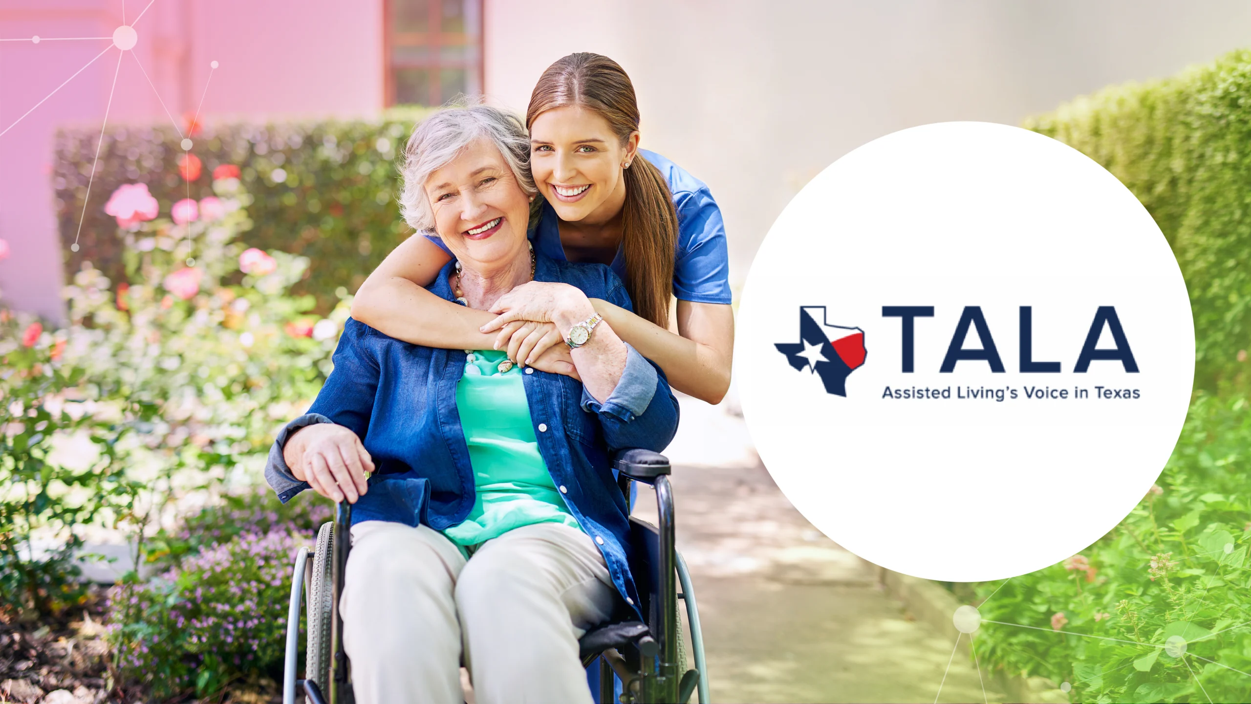 Smiling elderly woman in wheelchair hugged by caregiver outdoors with TALA assisted living logo.