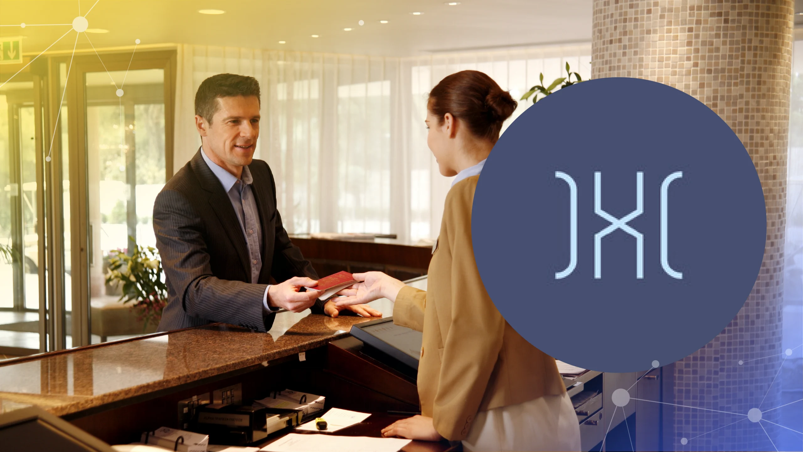 Man in suit handing passport to hotel receptionist at front desk inside lobby.