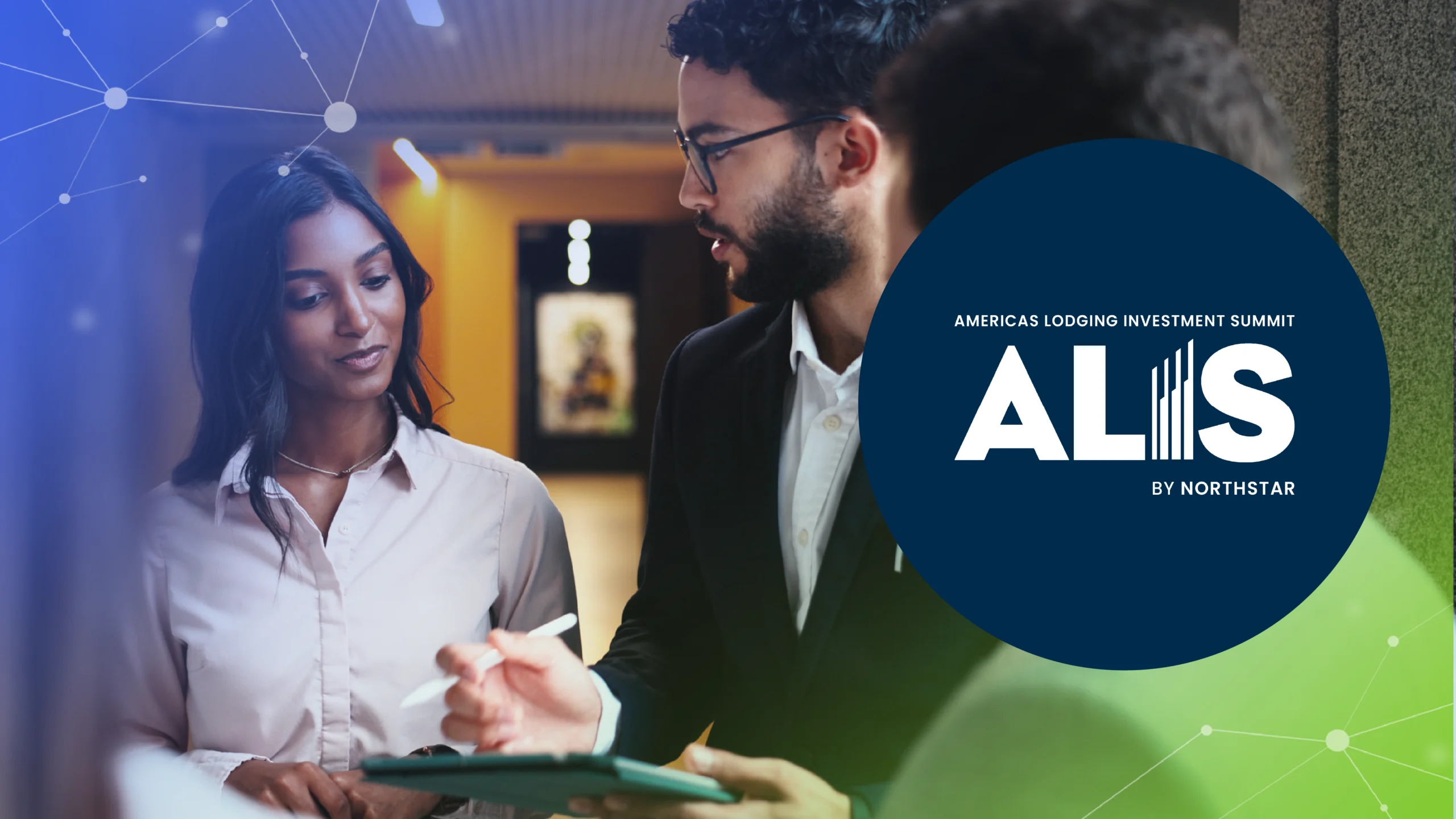 Two professionals discussing a tablet with ALIS Americas Lodging Investment Summit logo on the right.