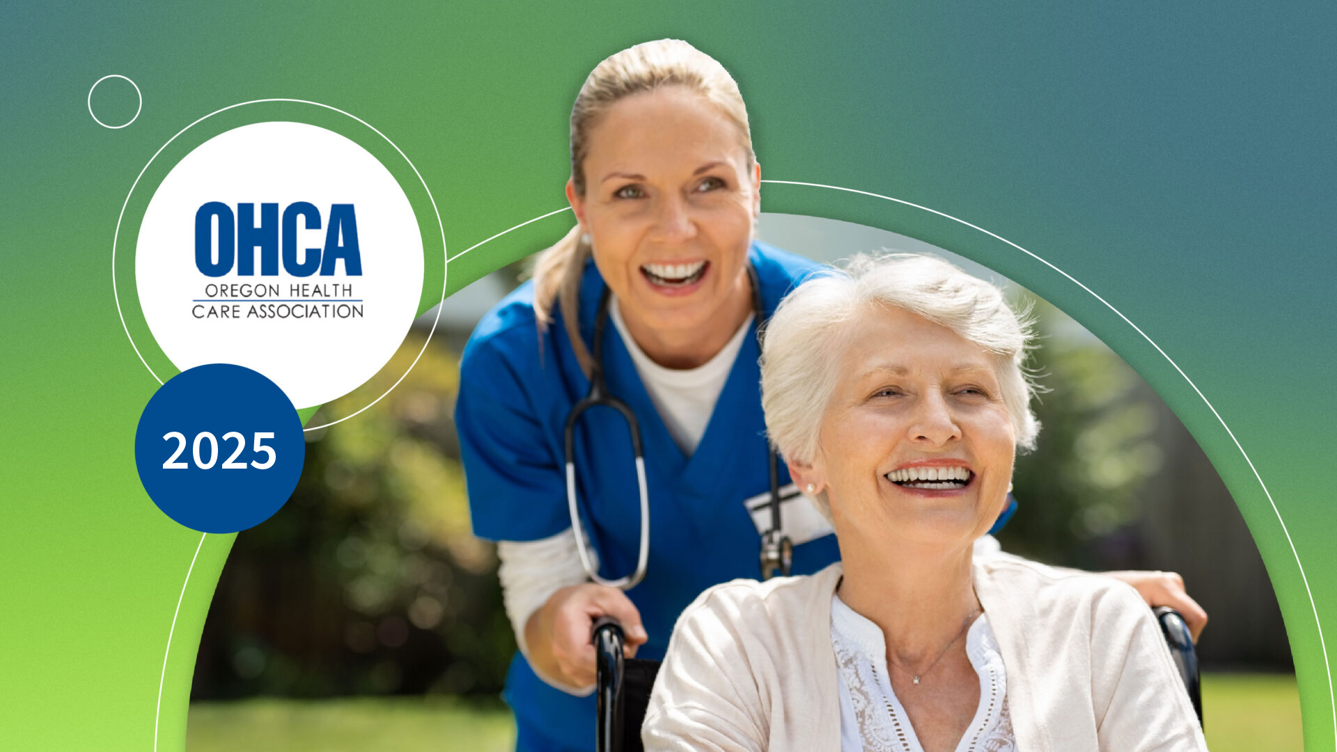 Smiling elderly woman in wheelchair pushed by happy nurse in blue scrubs outdoors.
