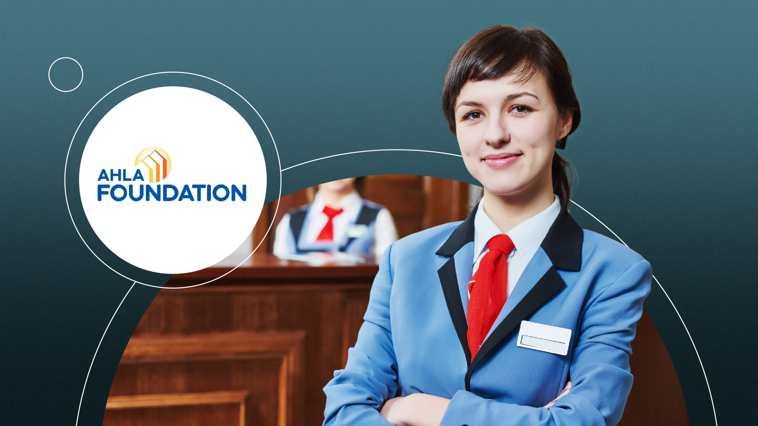 Woman hotel staff in blue uniform with red tie smiling, AHLA Foundation logo on left side.