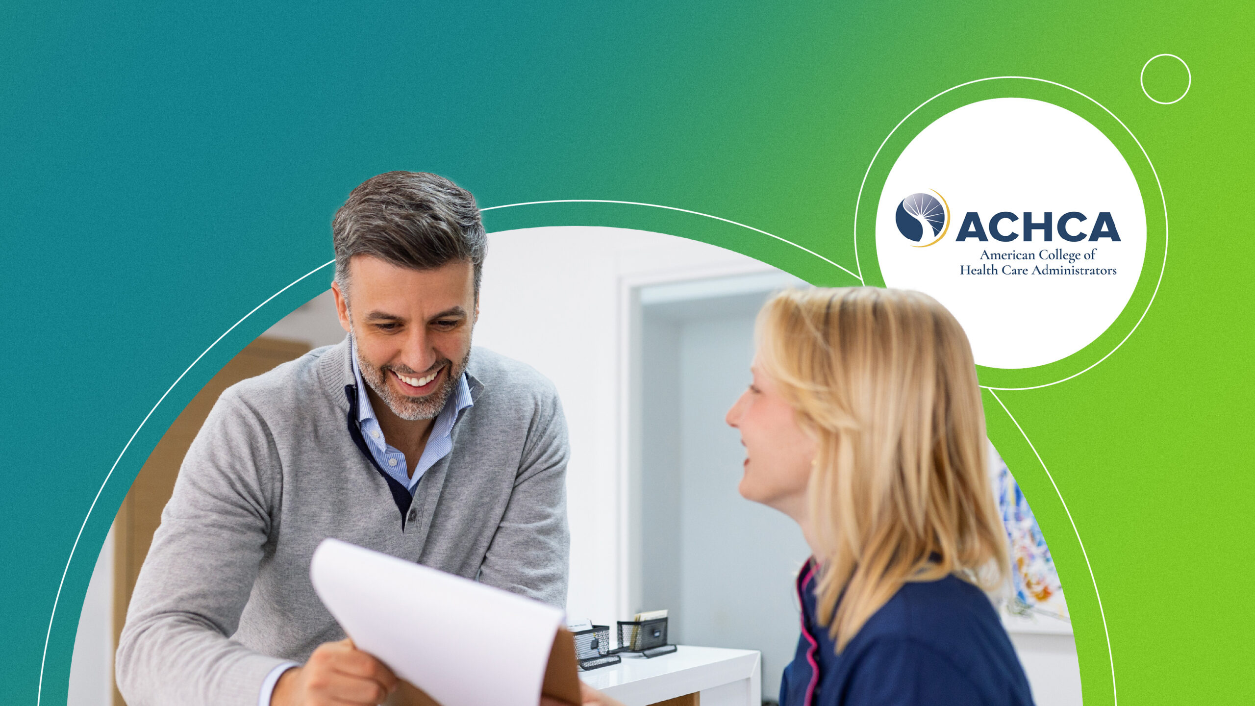 Two professionals smiling and reviewing documents in an office with ACHCA logo on green and blue background.