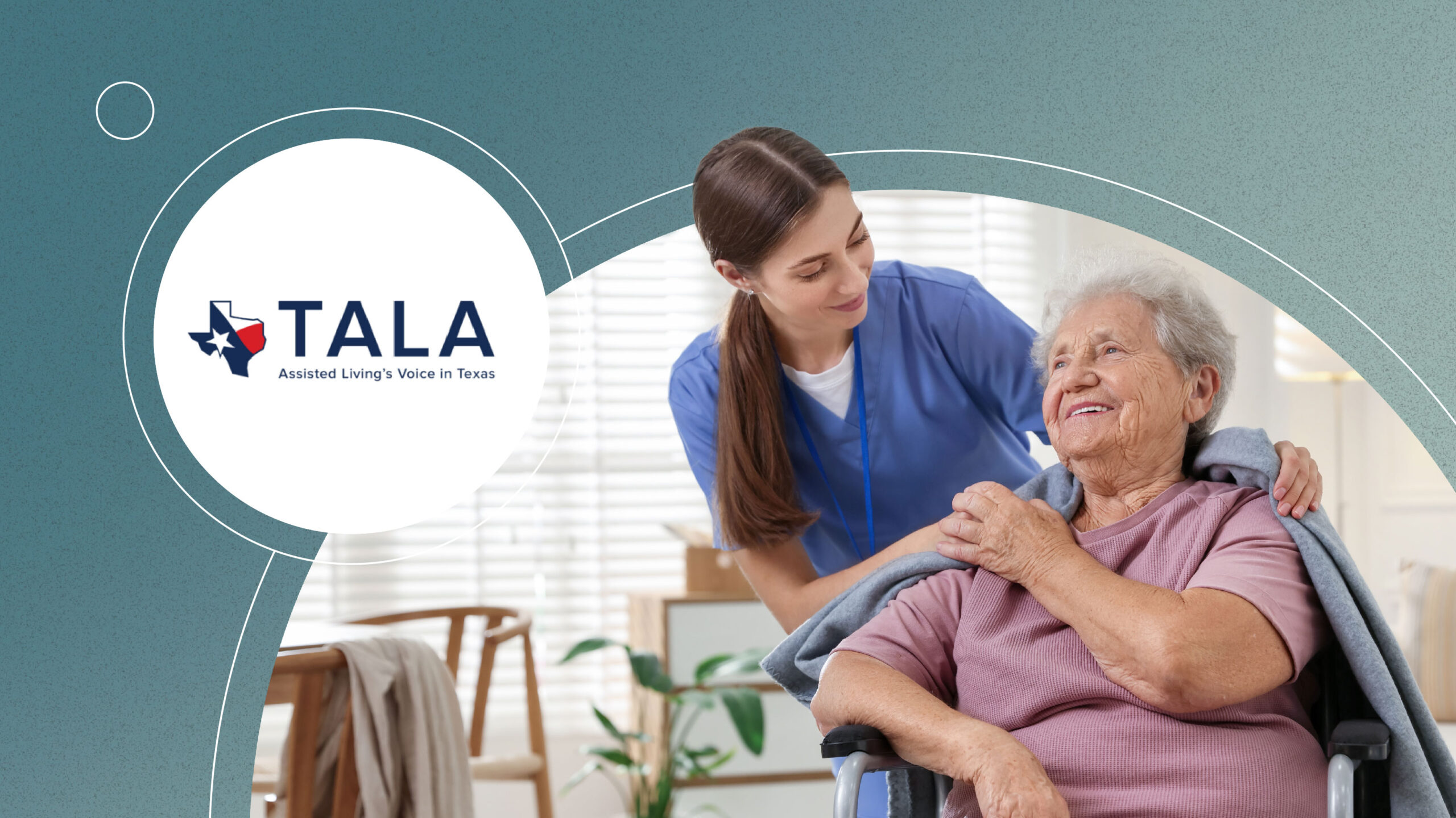 Caregiver in blue scrubs smiles as she helps elderly woman in wheelchair with a blanket.