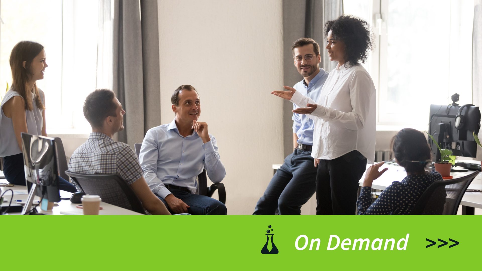 A diverse group of five colleagues having a discussion in a bright office setting.