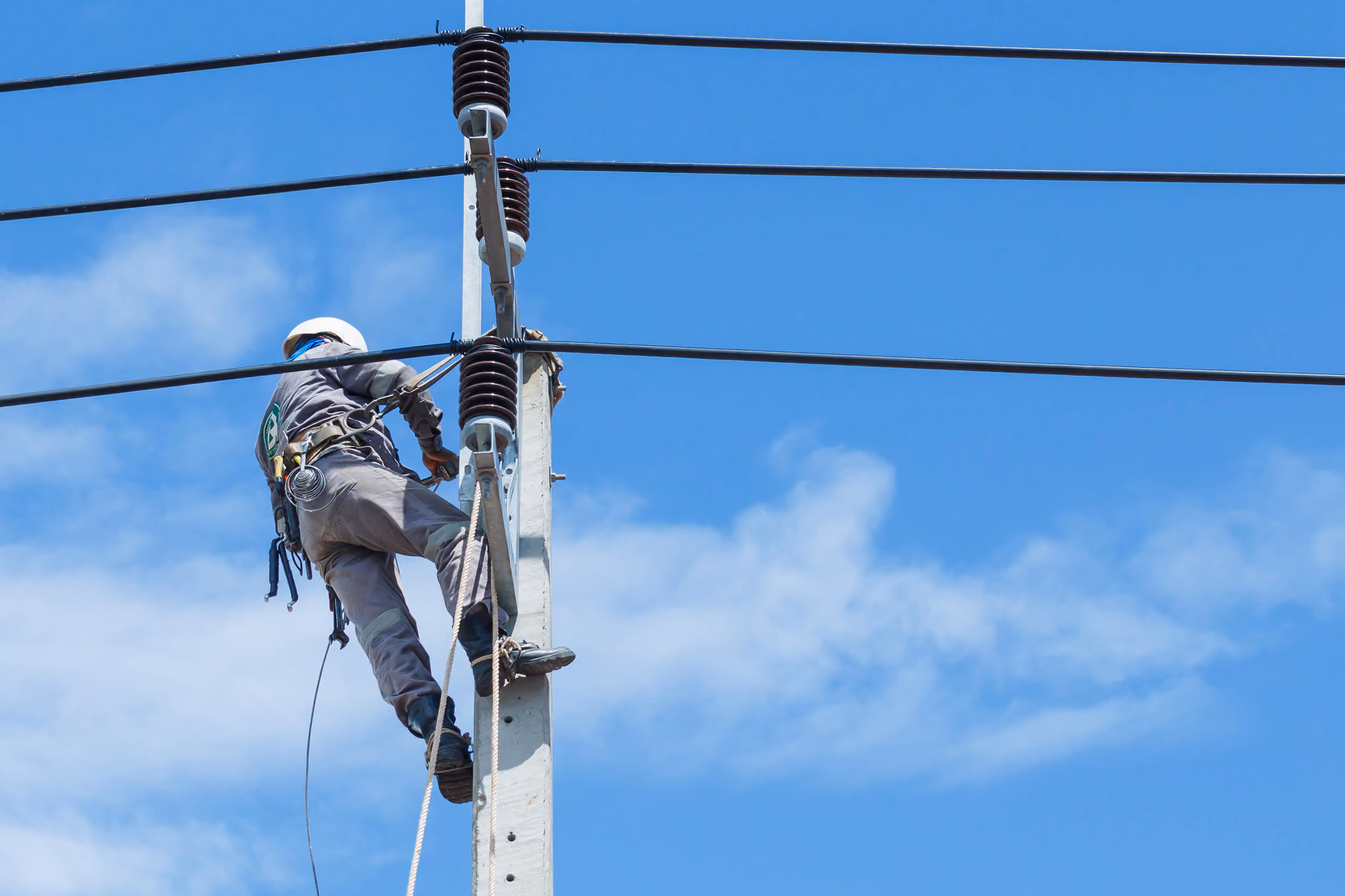 A man working on a telephone pole