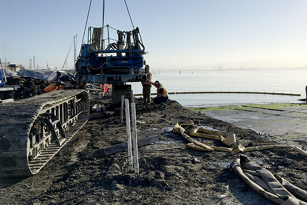 Industrial equipment operating on a shoreline site during an environmental or construction hygiene assessment