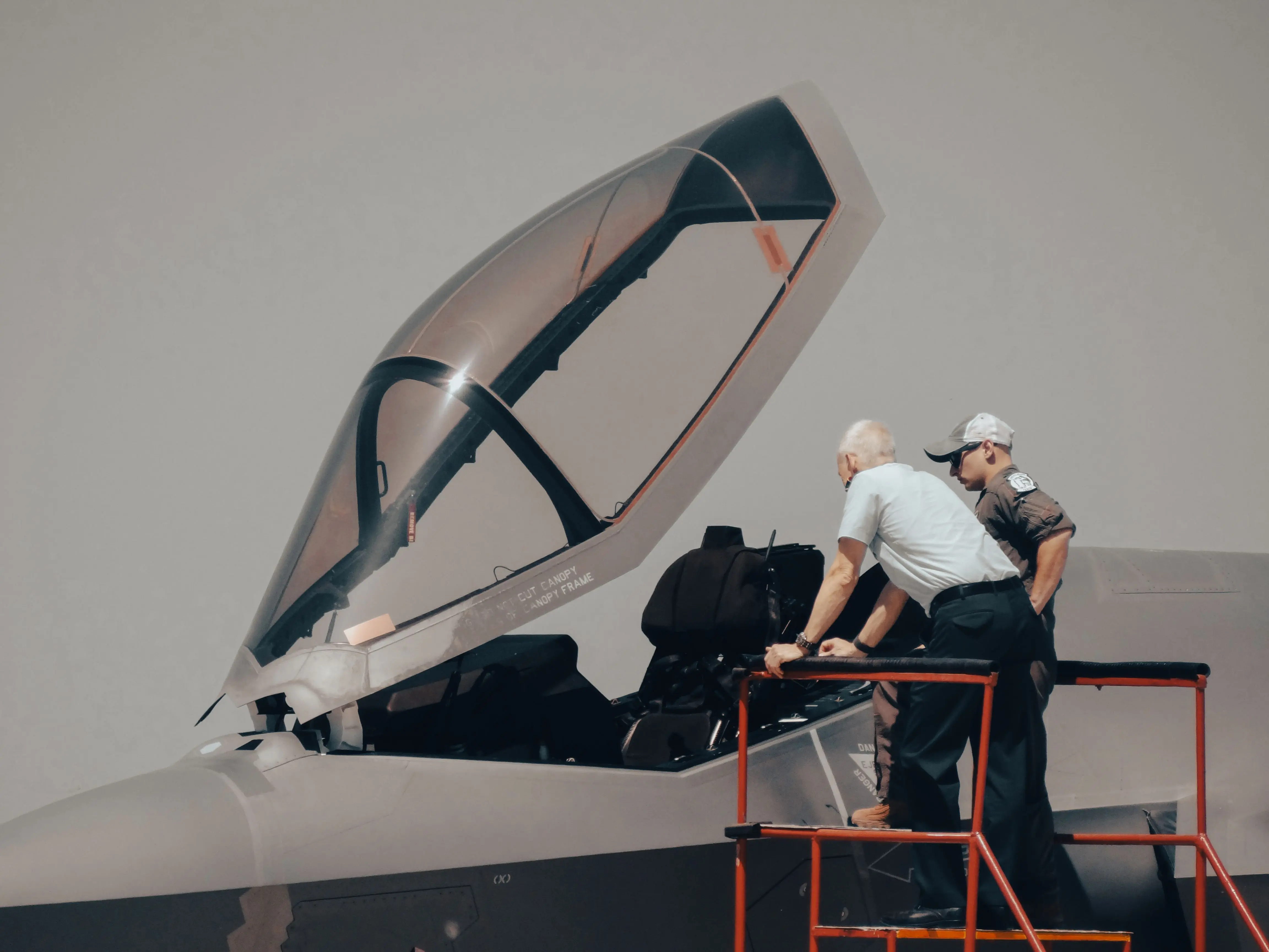 Pilot and mechanic look at fighter jet