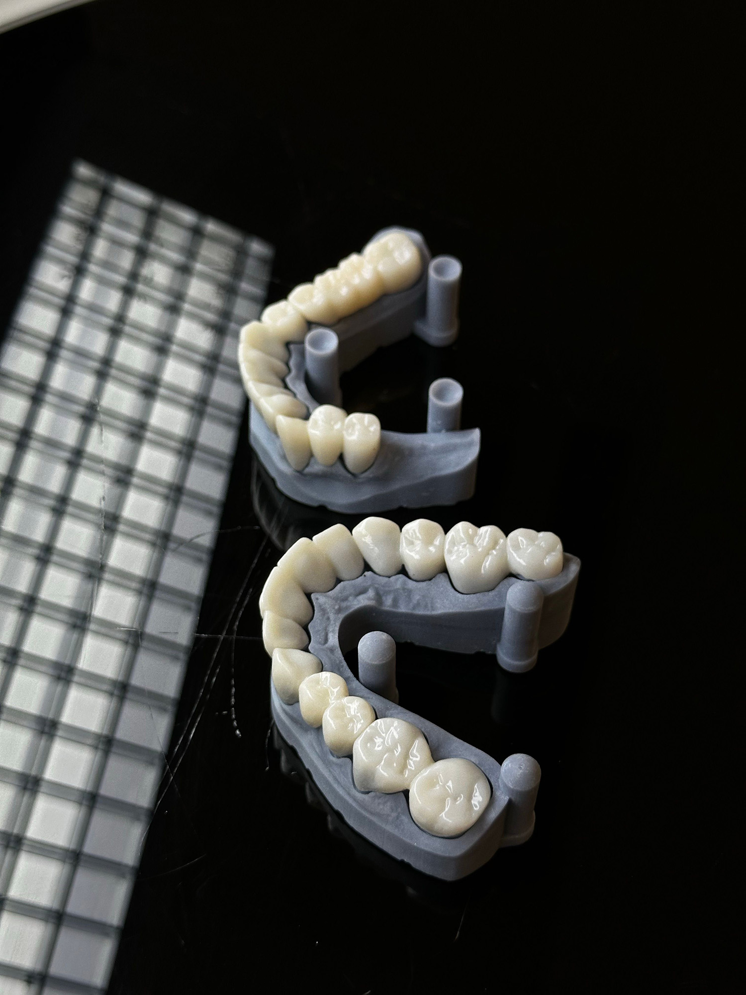 Toothbrush, toothpaste tube, and dental floss container on beige tiled surface.