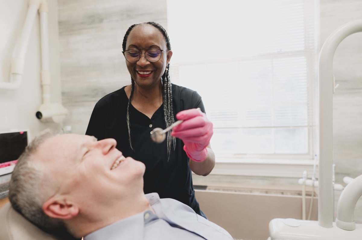 Dentist examining a patient's teeth during a dental cleaning appointment