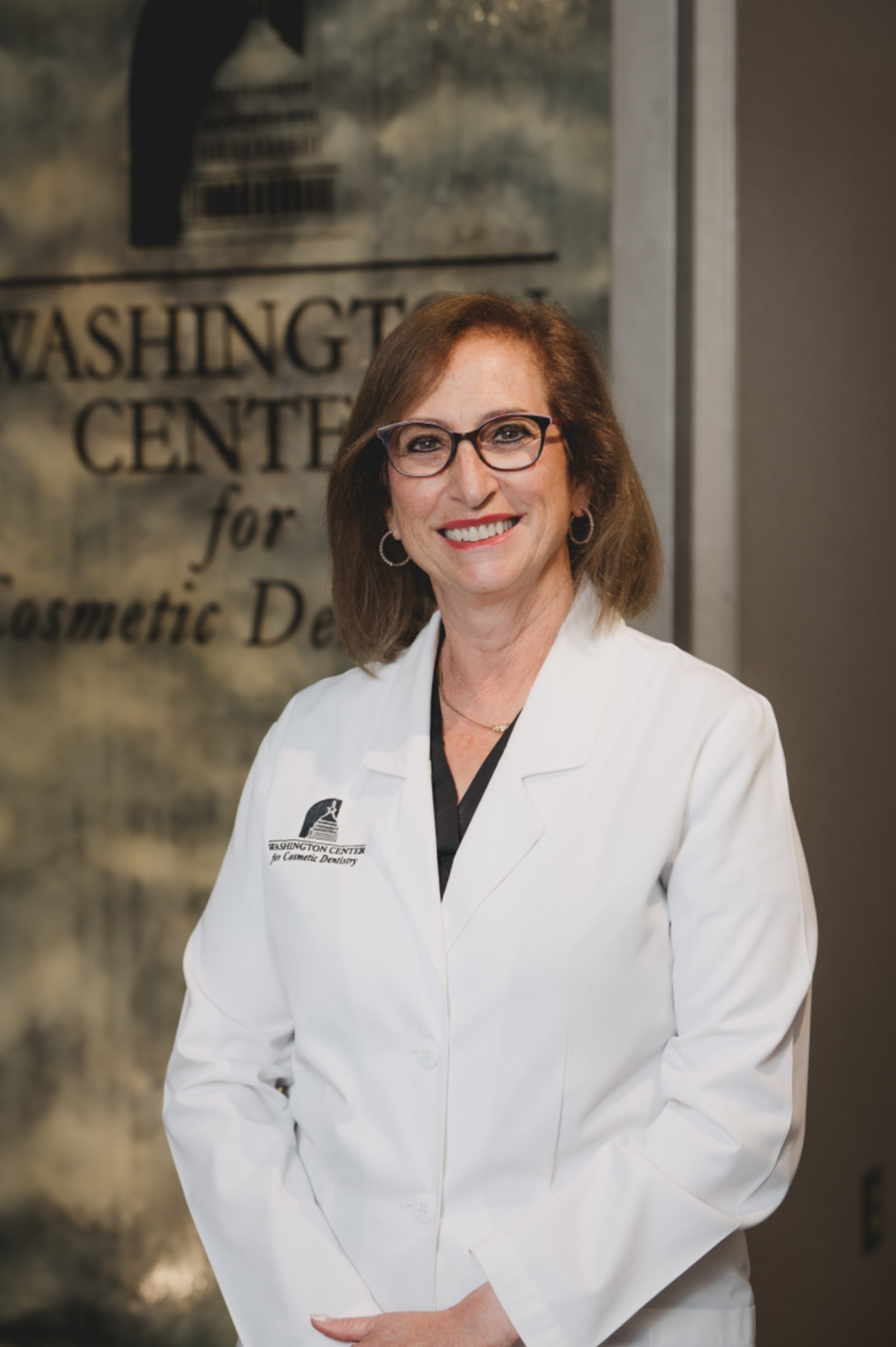 Female dentist in white coat portrait at Washington Center for Cosmetic and Family Dentistry
