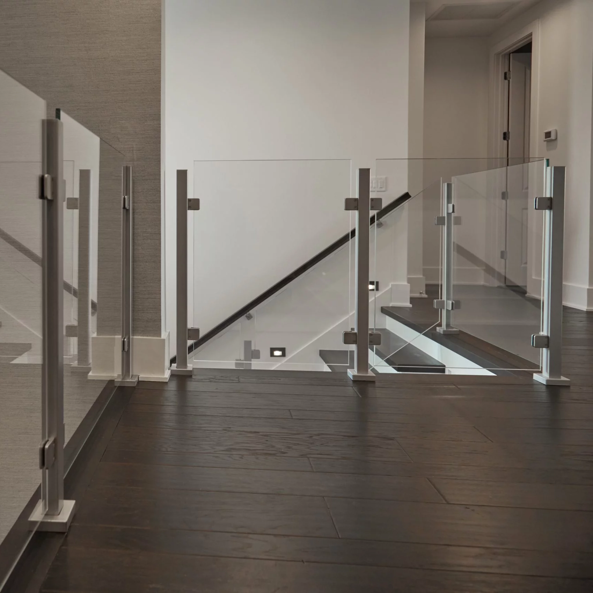 Barrier glass on a second floor landing next to stairs