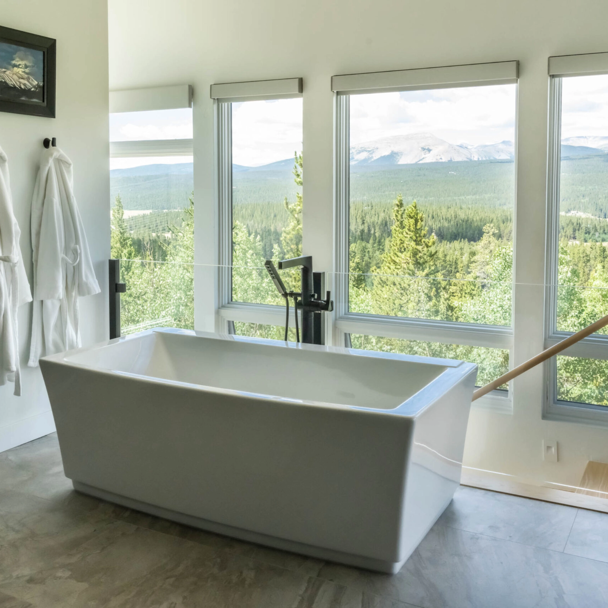 Glass post system set behind a bathtub with sweeping views through large windows