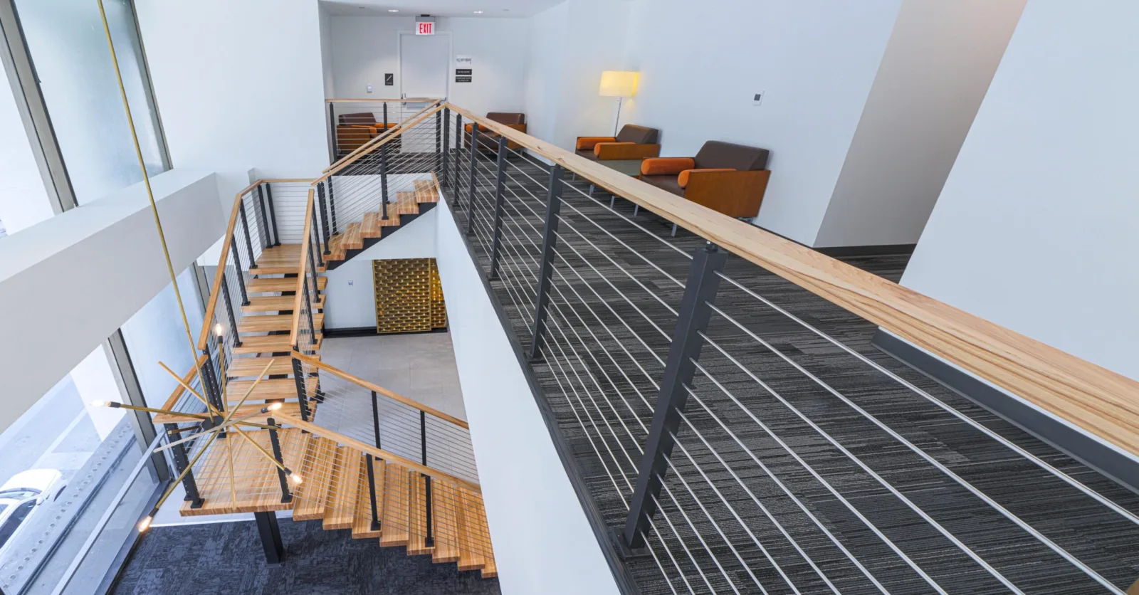 Panoramic overhead of the flight and the balcony railing that meets it