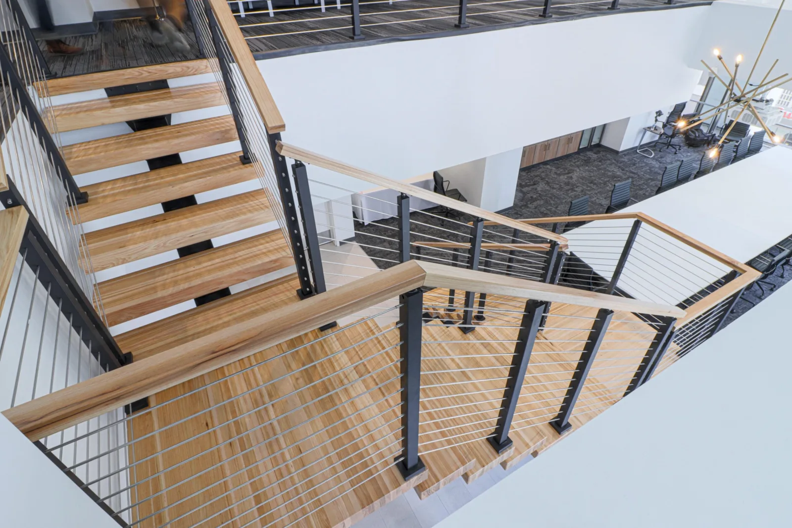 Overhead view down the flights, wood top rail and slatted wall below
