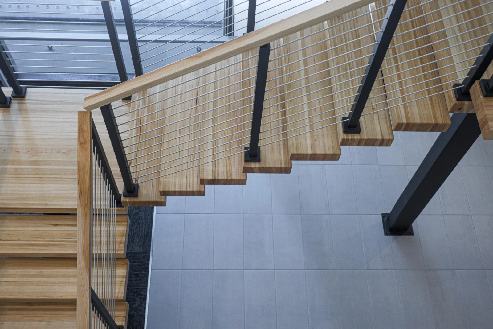 Low angle along the underside of treads and black posts above tile