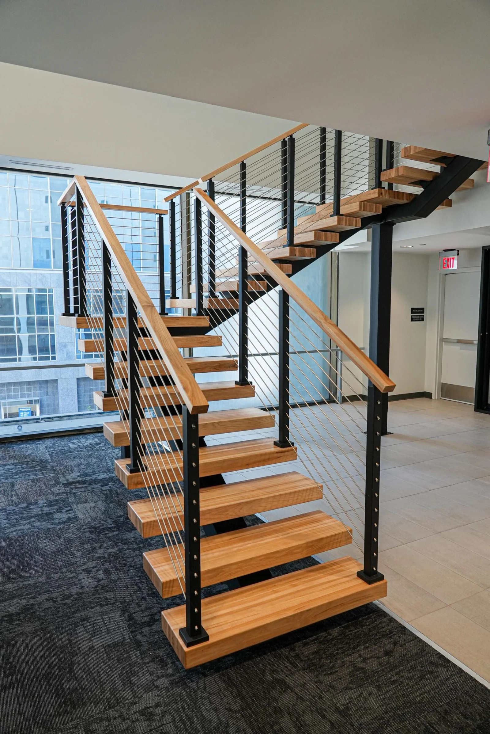 Straight-on view of the switchback flight, open risers and black cable infill