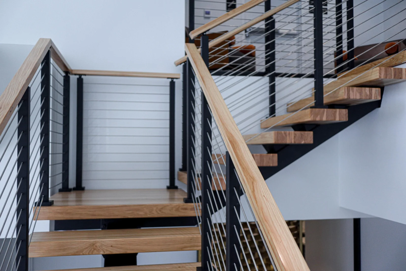 Looking up from the bottom step toward the landing and upper flight