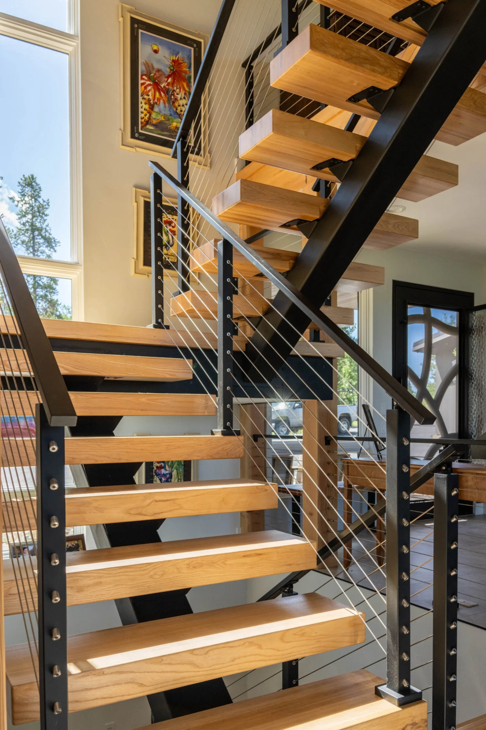 Switchback flights with open risers and cable infill seen from the floor below