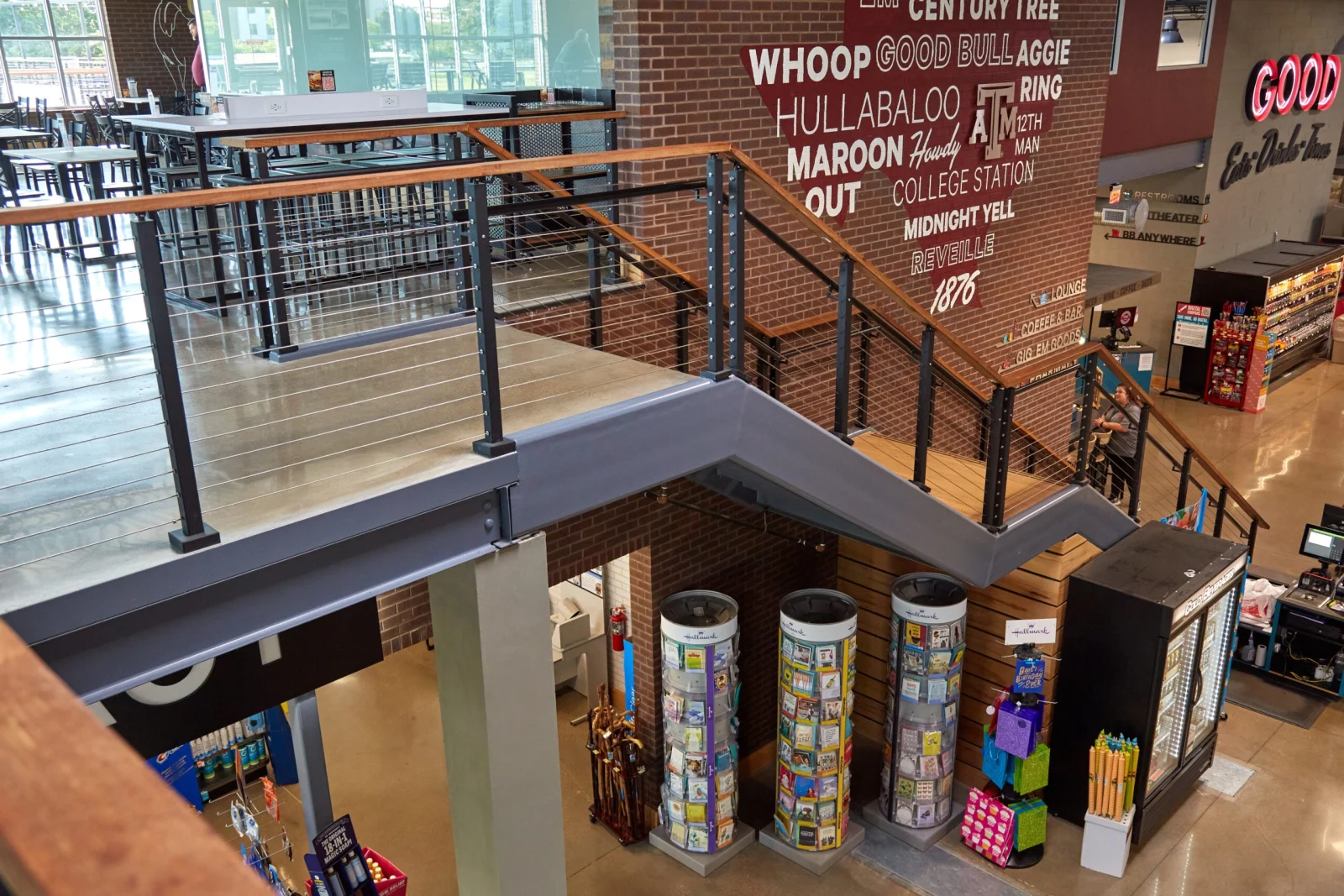 Overhead view of the mezzanine run and stair rail wrapping a brick corner