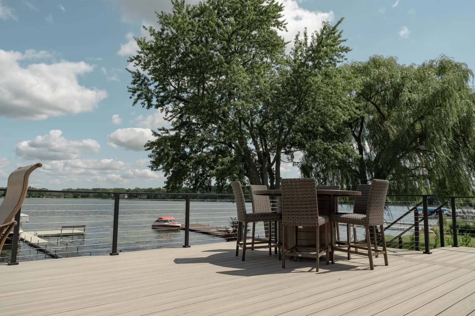 Bar table and stools on the deck inside the cable railing perimeter