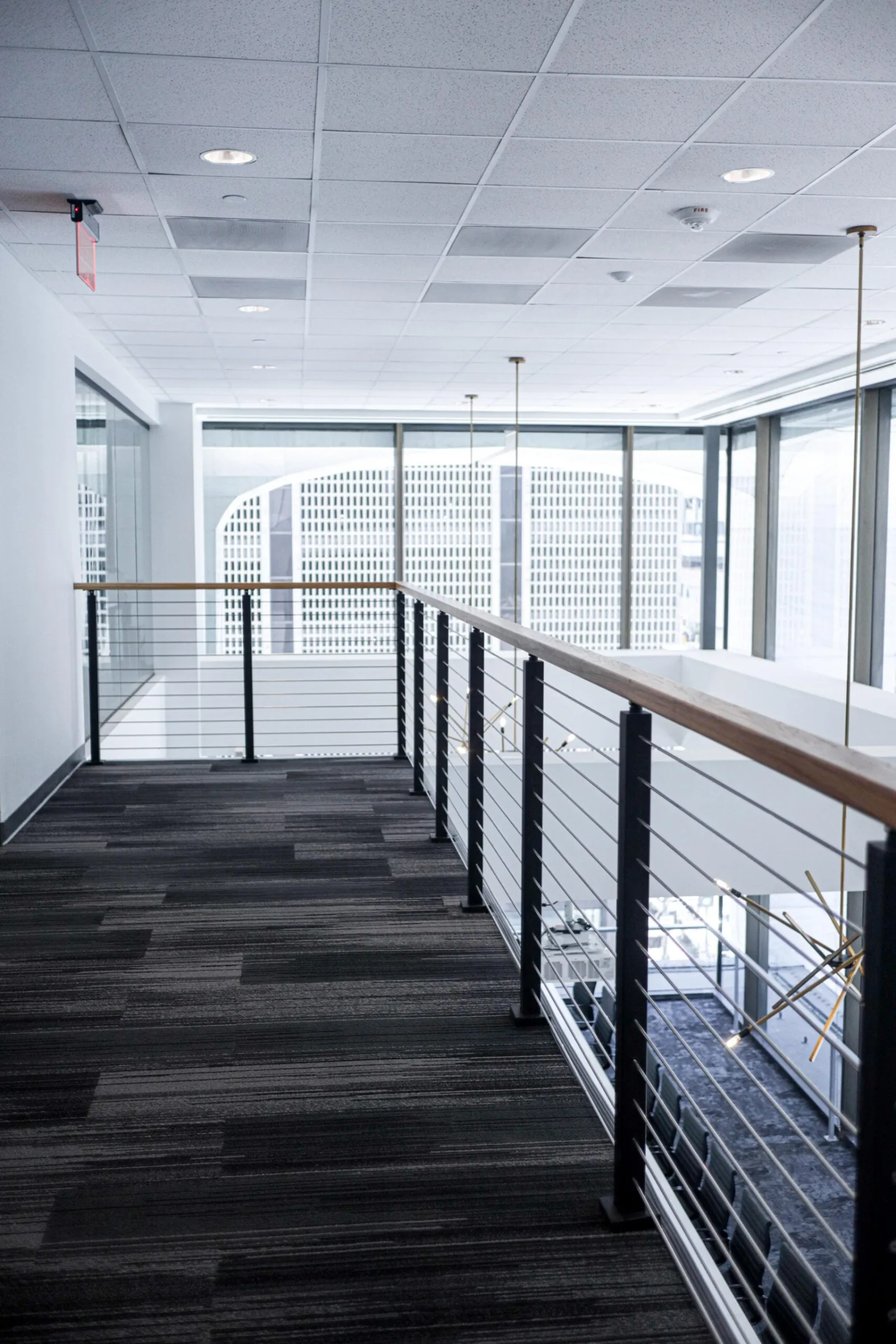 Carpeted walkway between glazing and the railing with the skyline beyond