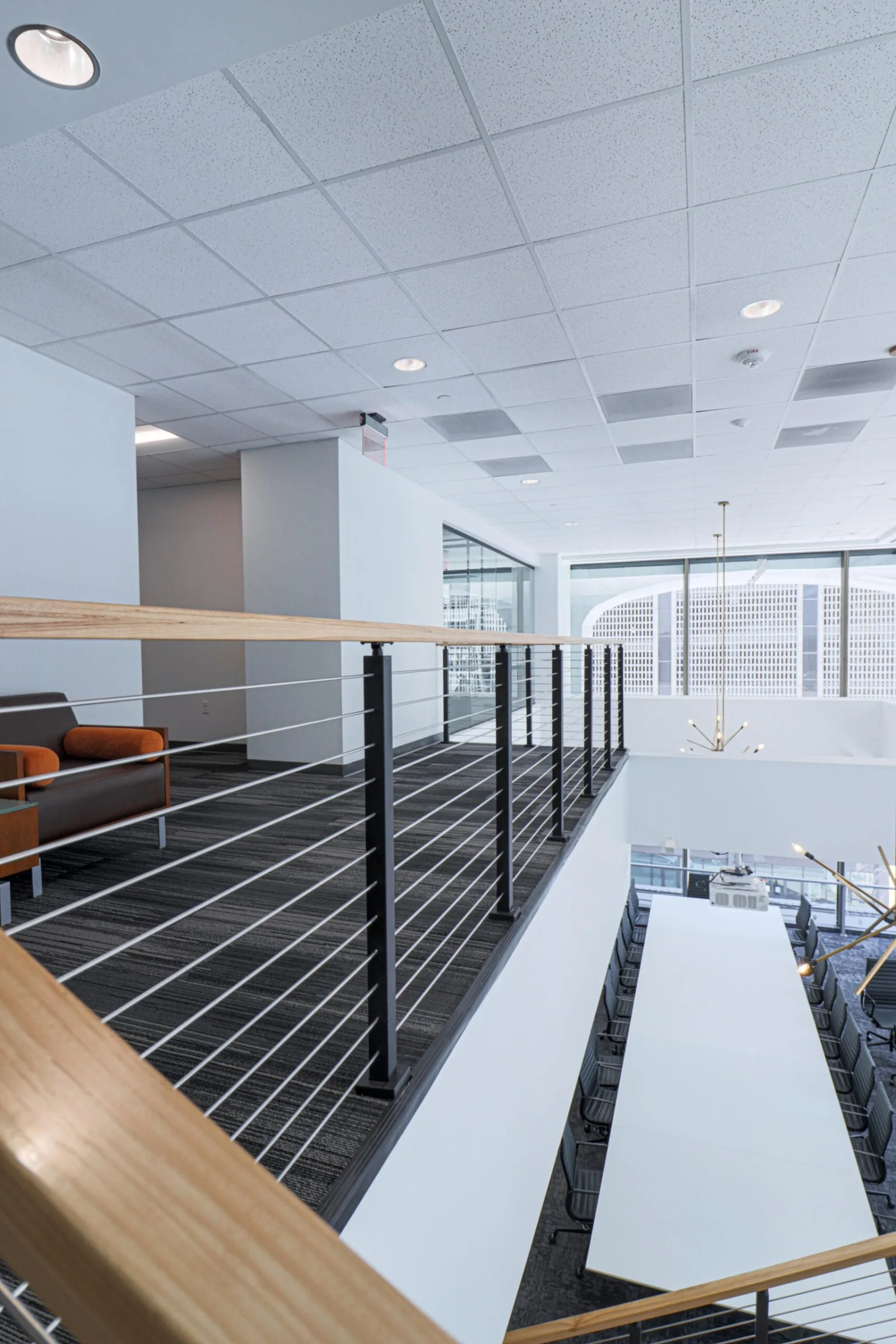 Balcony railing overlooking a conference table in the open floor below