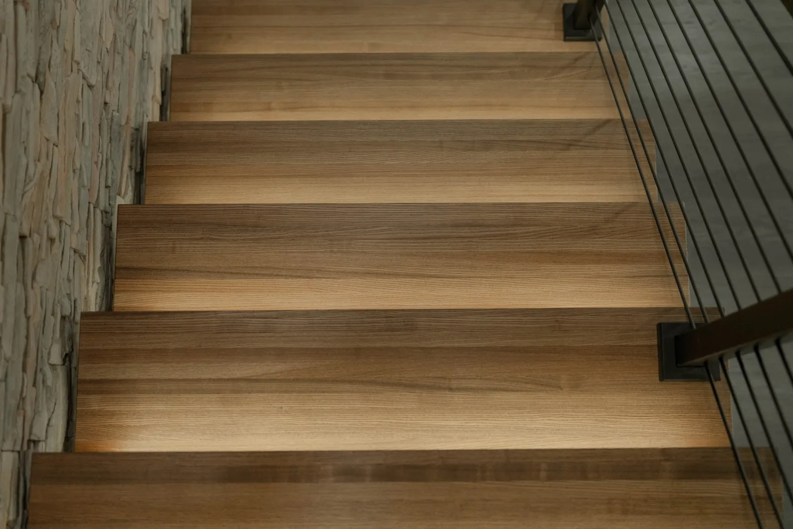 Overhead view of wide wood treads with open risers and lighting between them