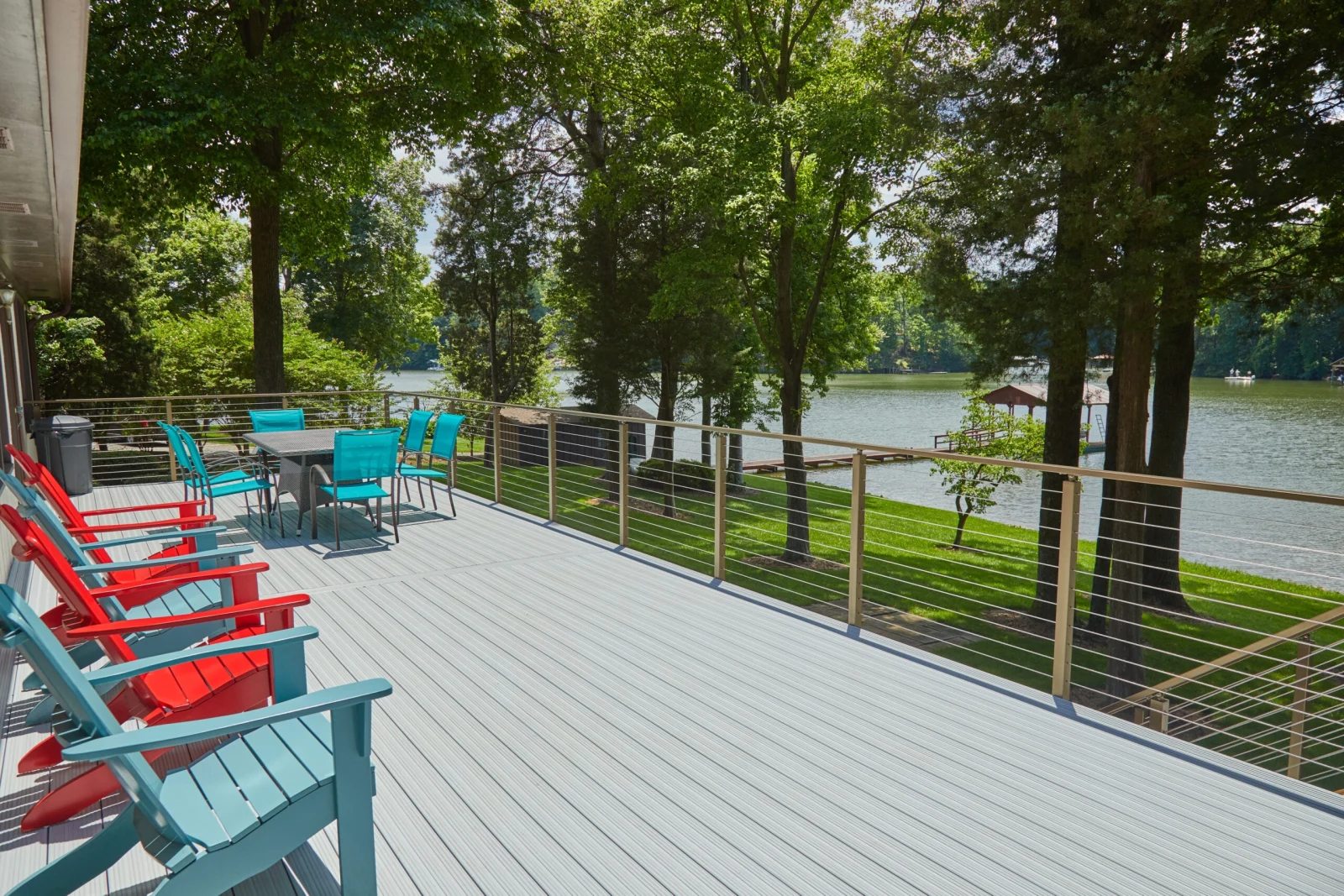 Deck seating and dining set with cable railing opening to the water