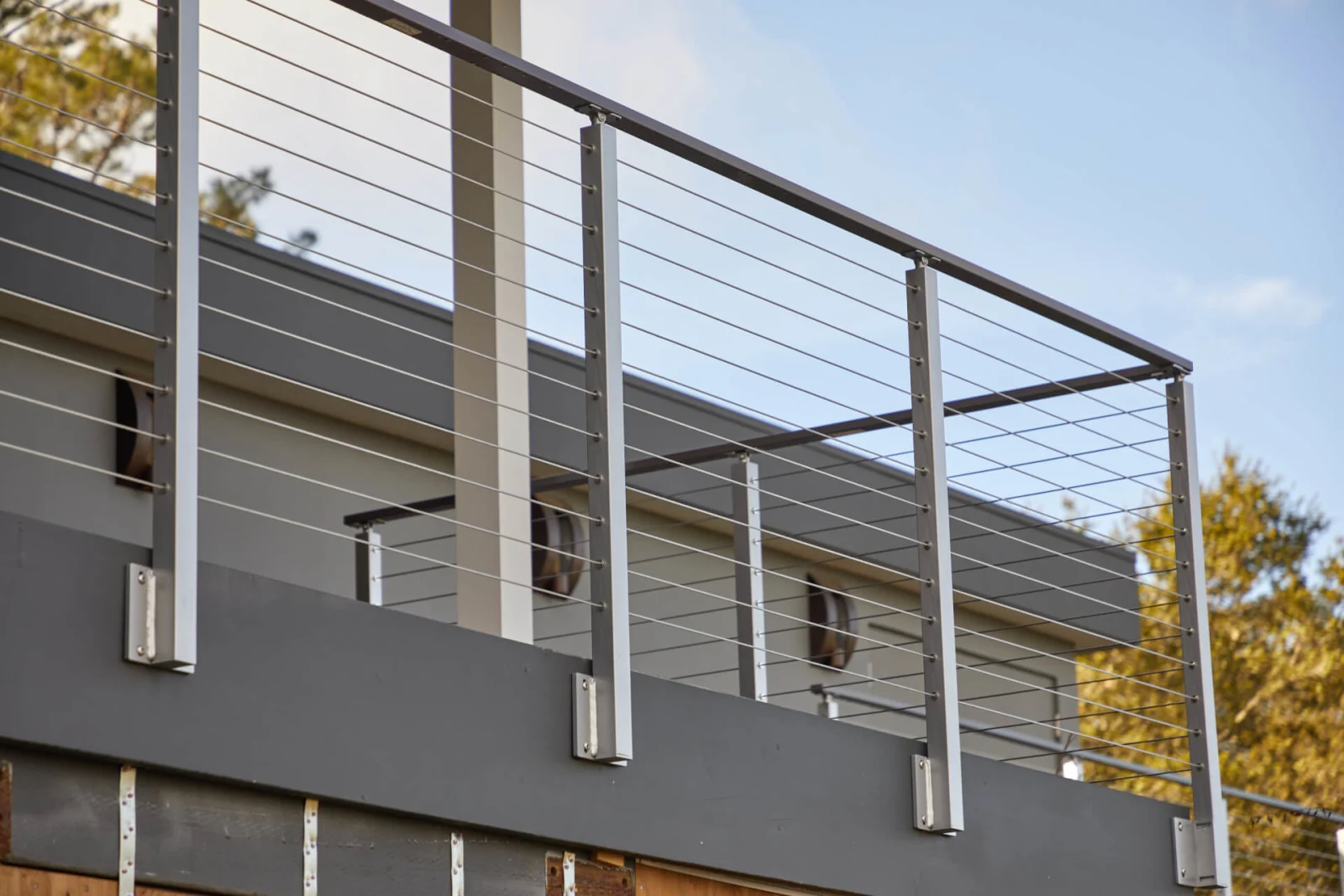 Angled view of posts fixed to a dark fascia below an upper deck