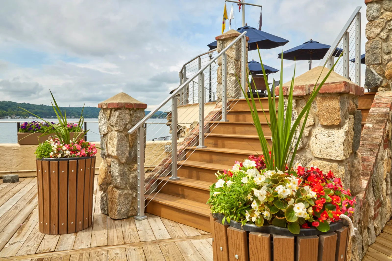 Cable railing at the foot of the stairs beside flowering planters