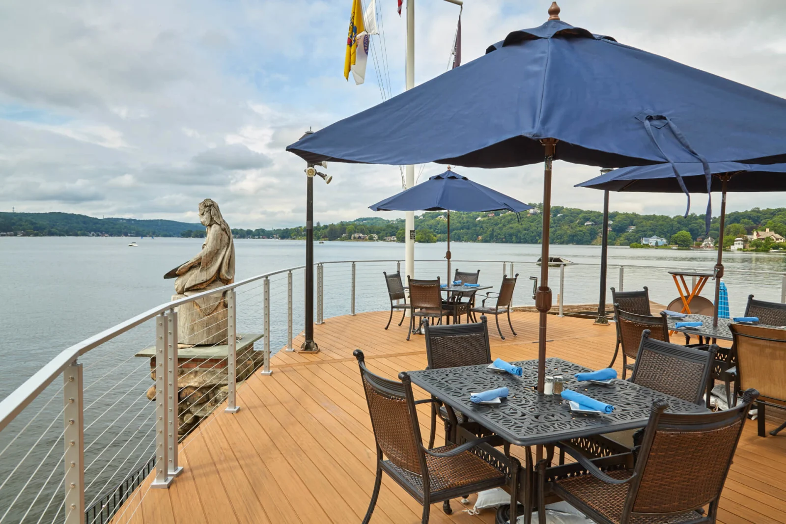Curved railing tracing the deck edge above the water past dining tables