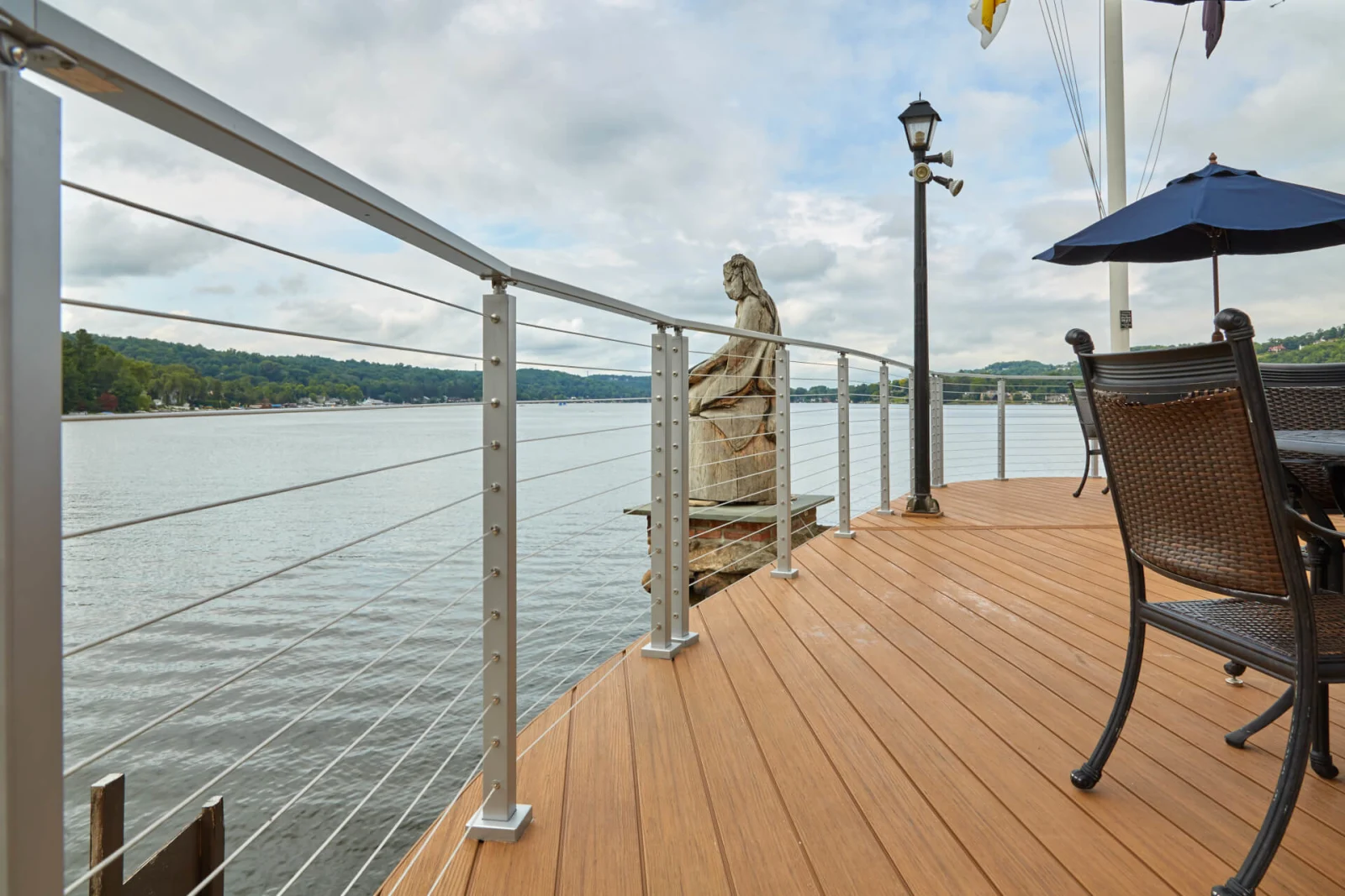 Cable railing curving around a deck corner overlooking the open lake