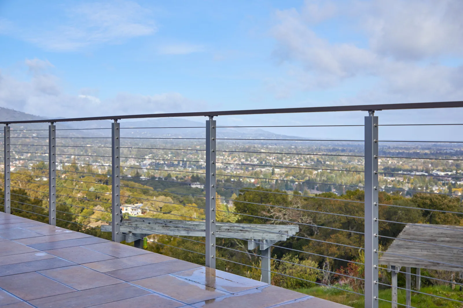 Long terrace railing with a paver floor and sweeping valley outlook