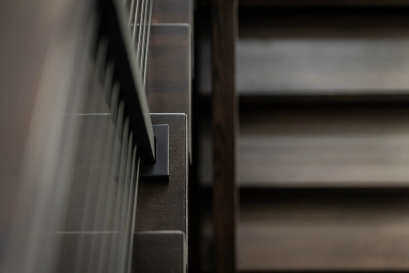 Tight abstract of rod ends anchored into the stringer beside blurred treads