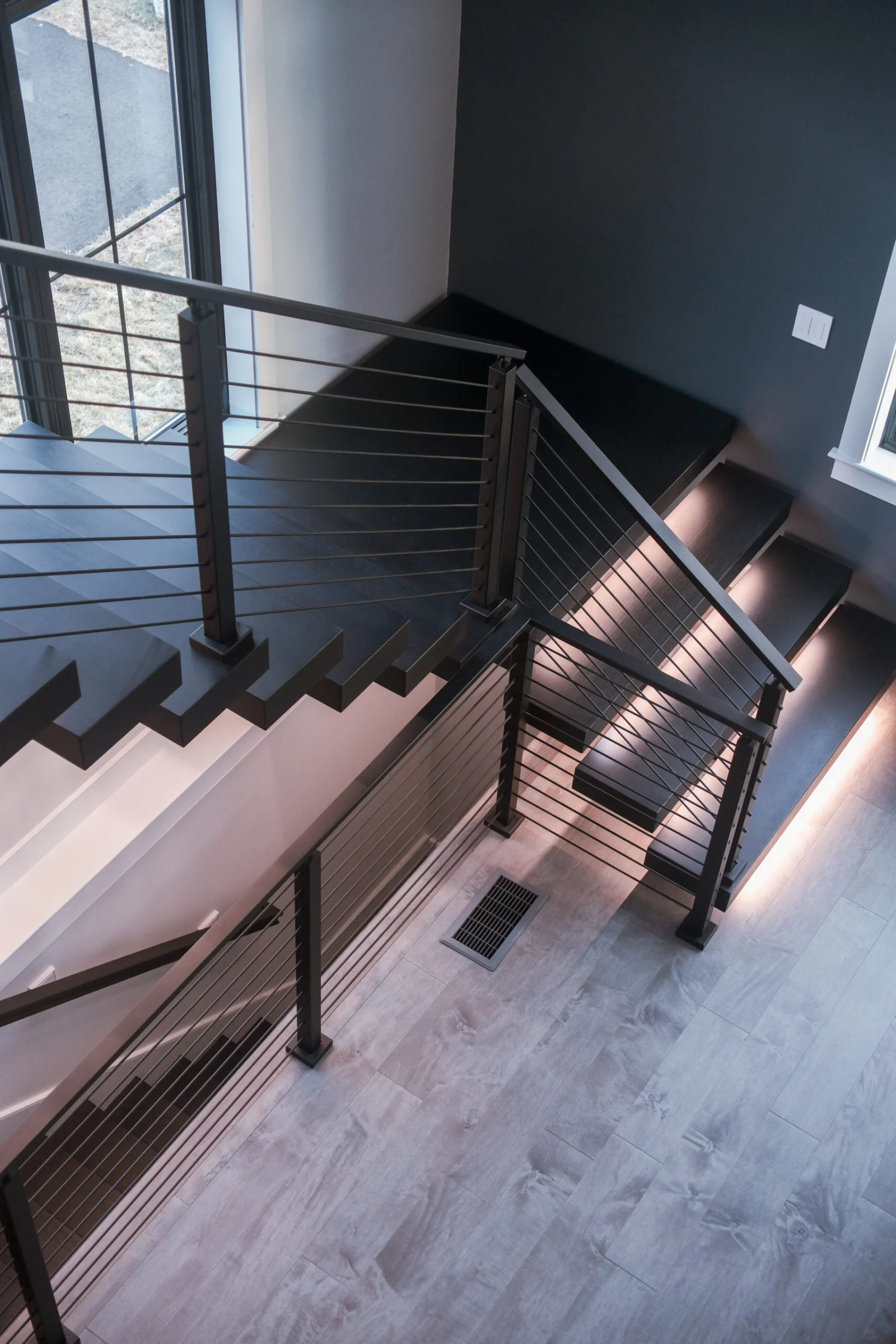 Looking down from the upper level at the flight and rod railing runs