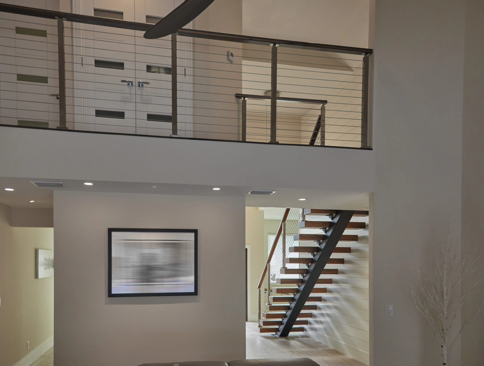 Overlook cable railing above an open room with the stair beyond