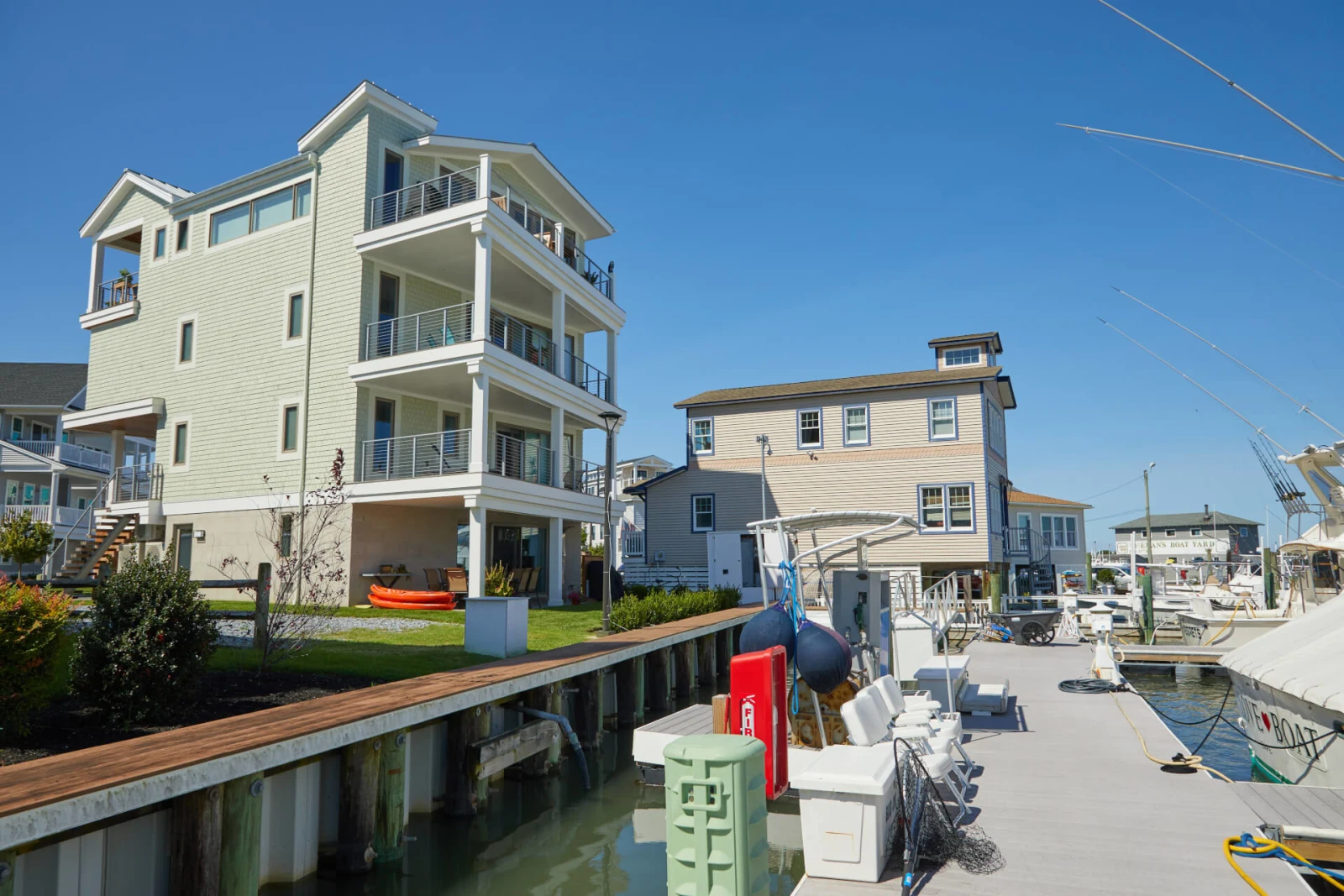 House and dock seen from the water with railed porches facing the marina