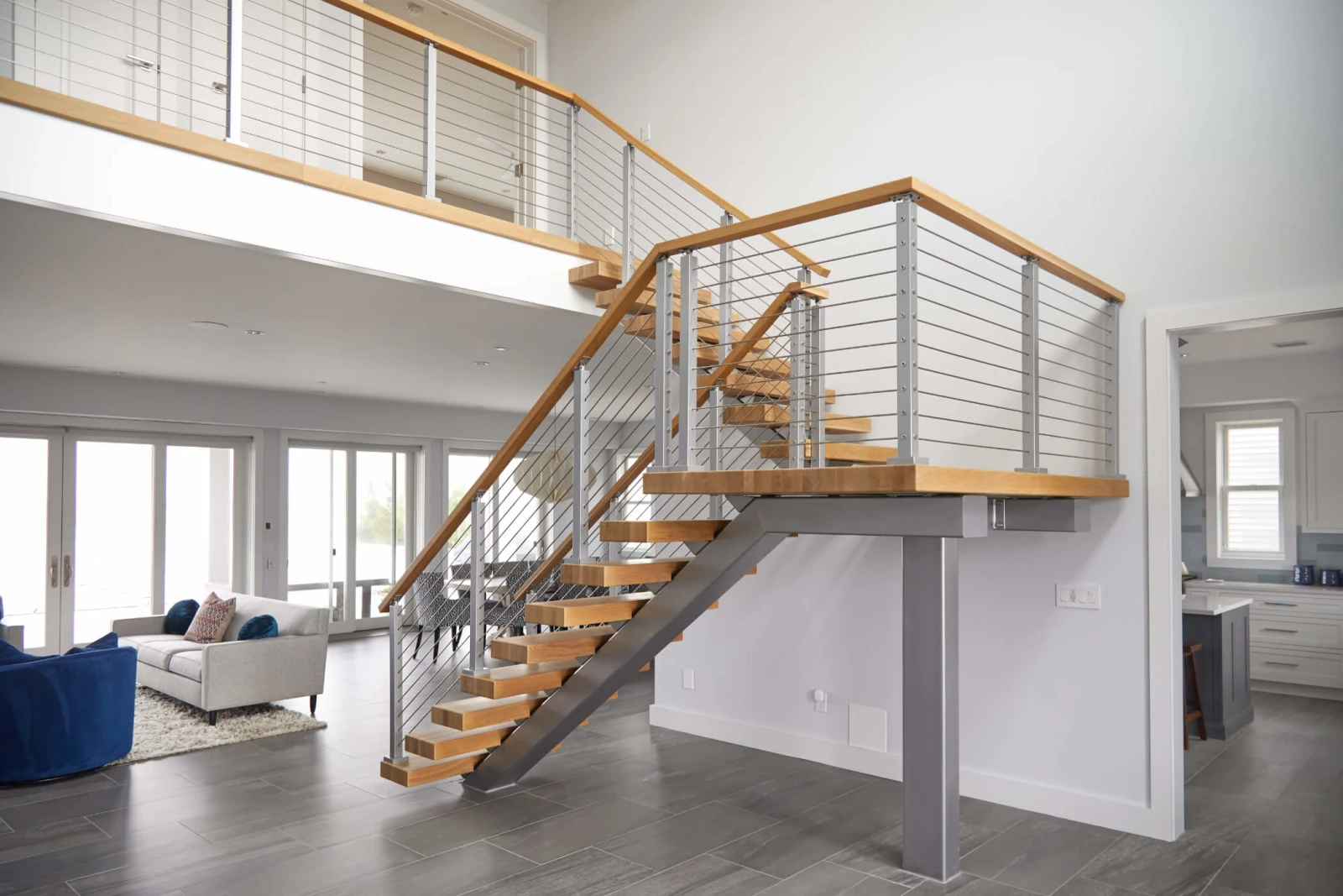 Stair and upper balcony run seen across the open living area