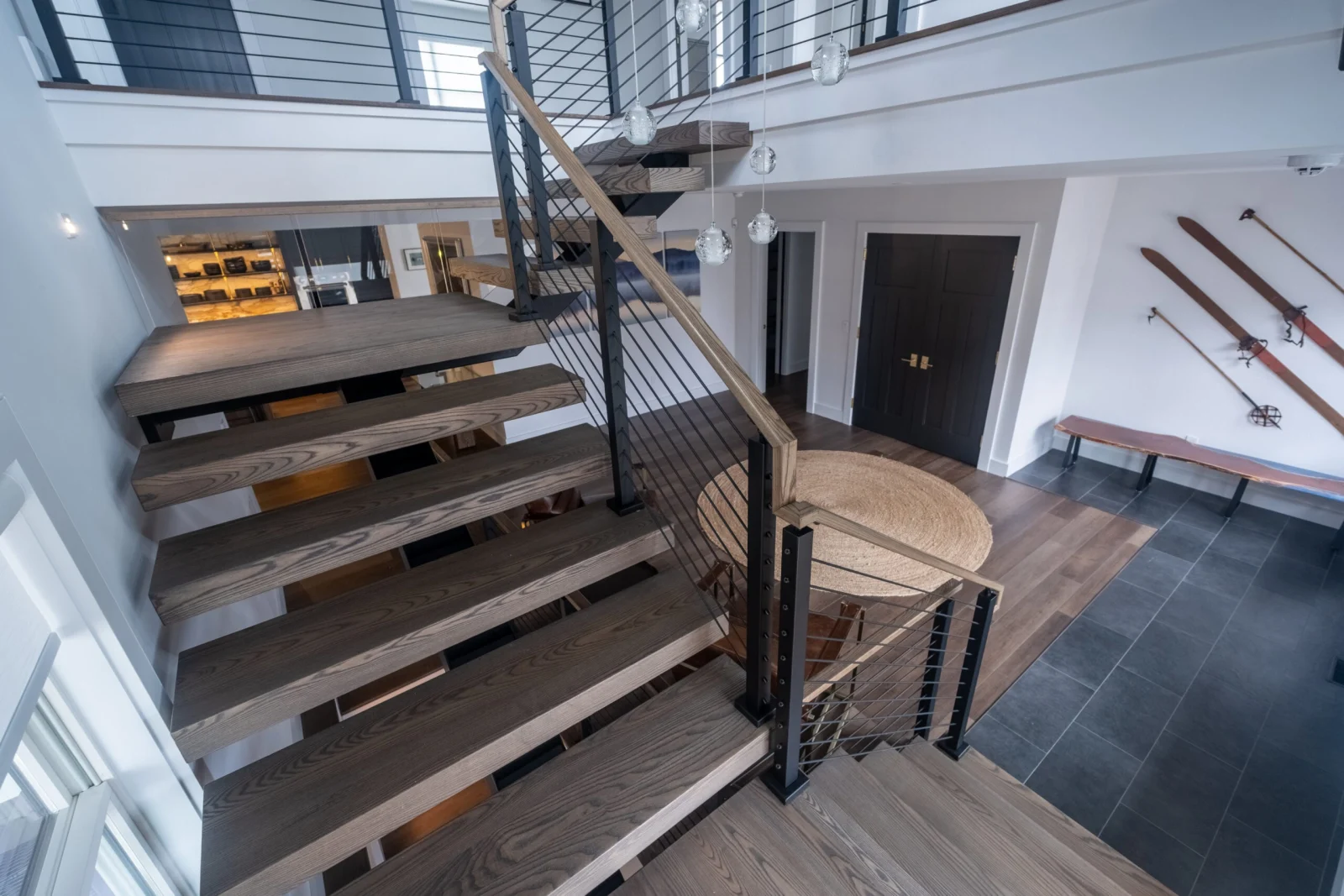 From the top landing, the flight descends to an entry with bench seating