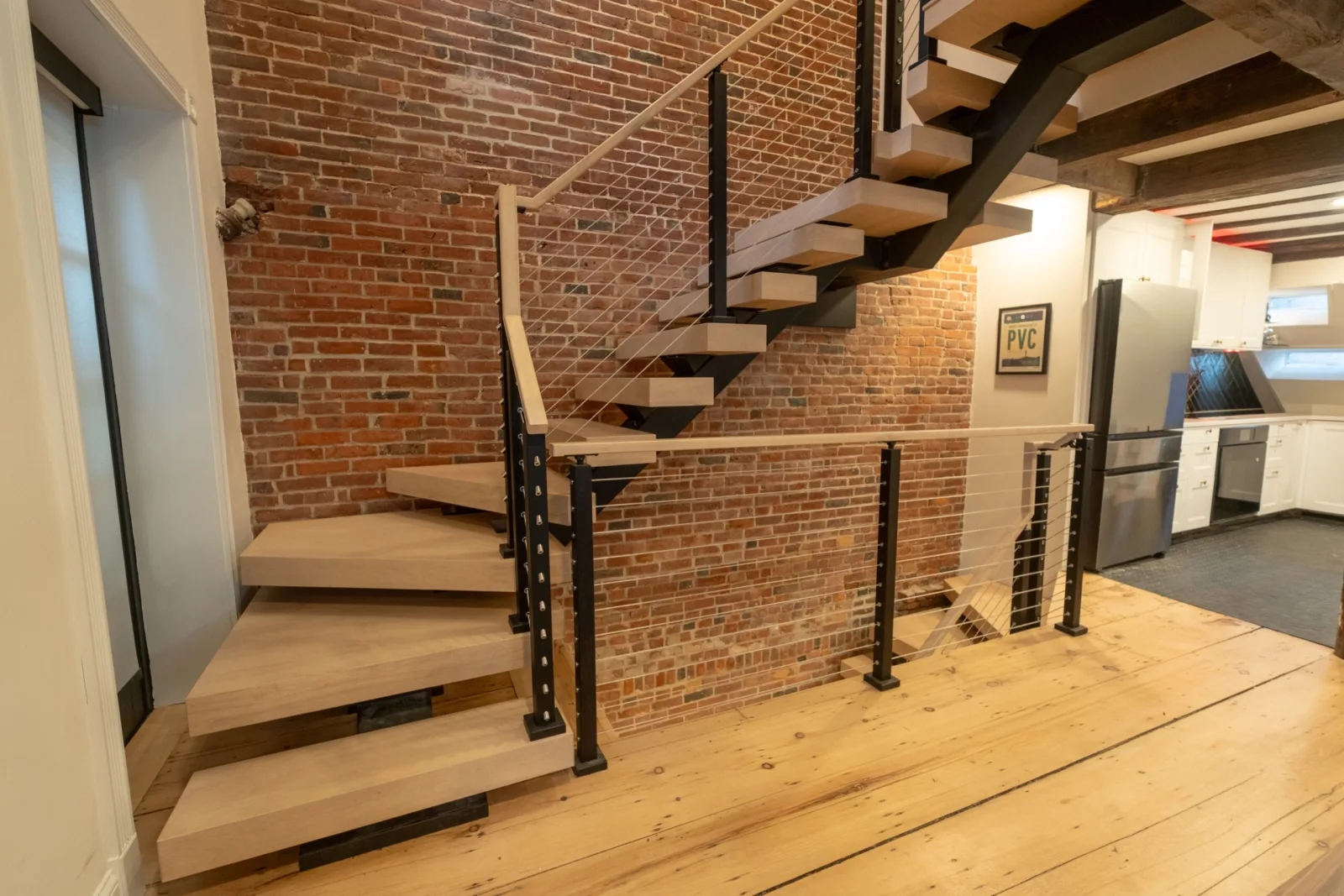 Angled view of the stair and winders with the kitchen beyond