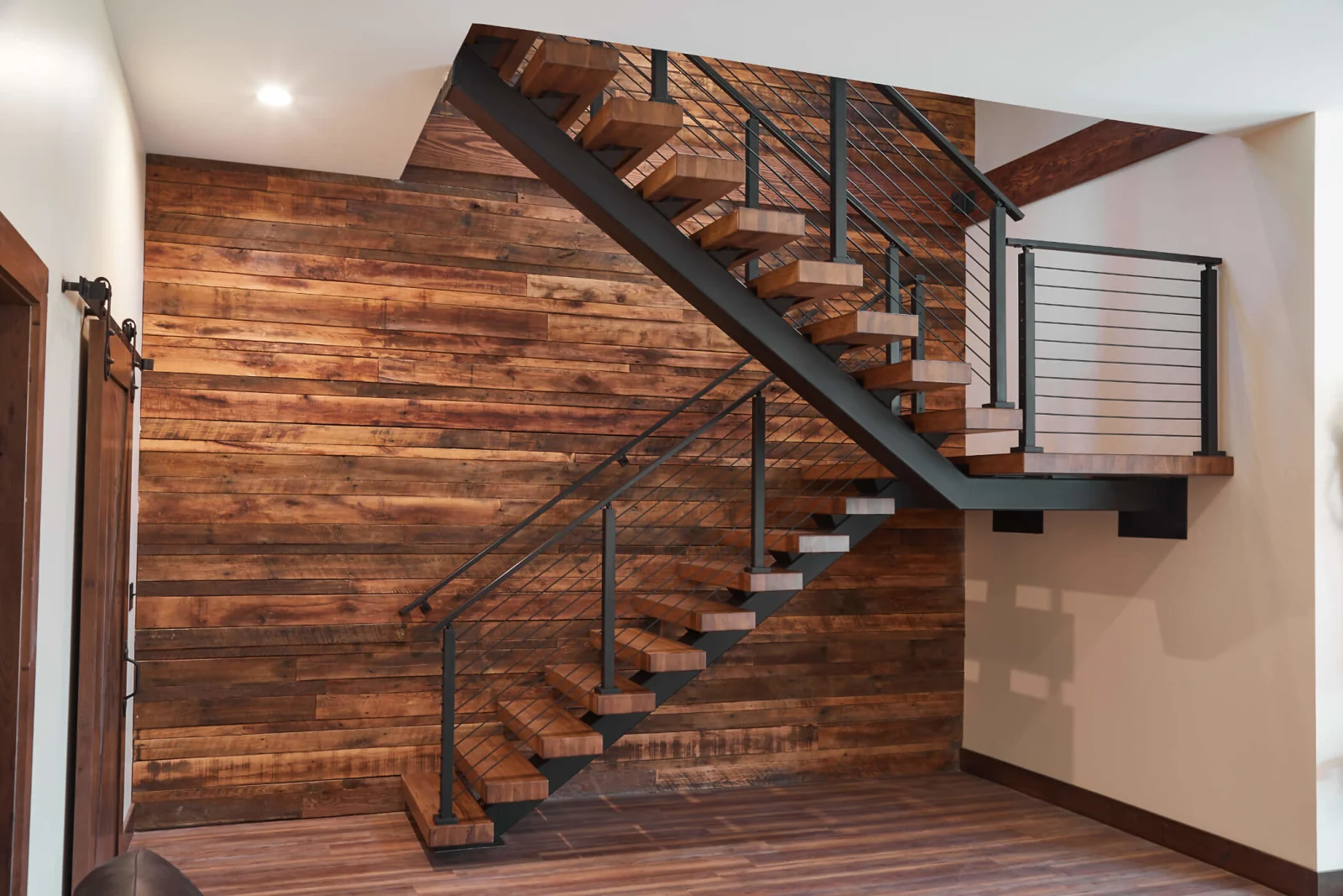 Wide view of the two flights and landing on the plank feature wall