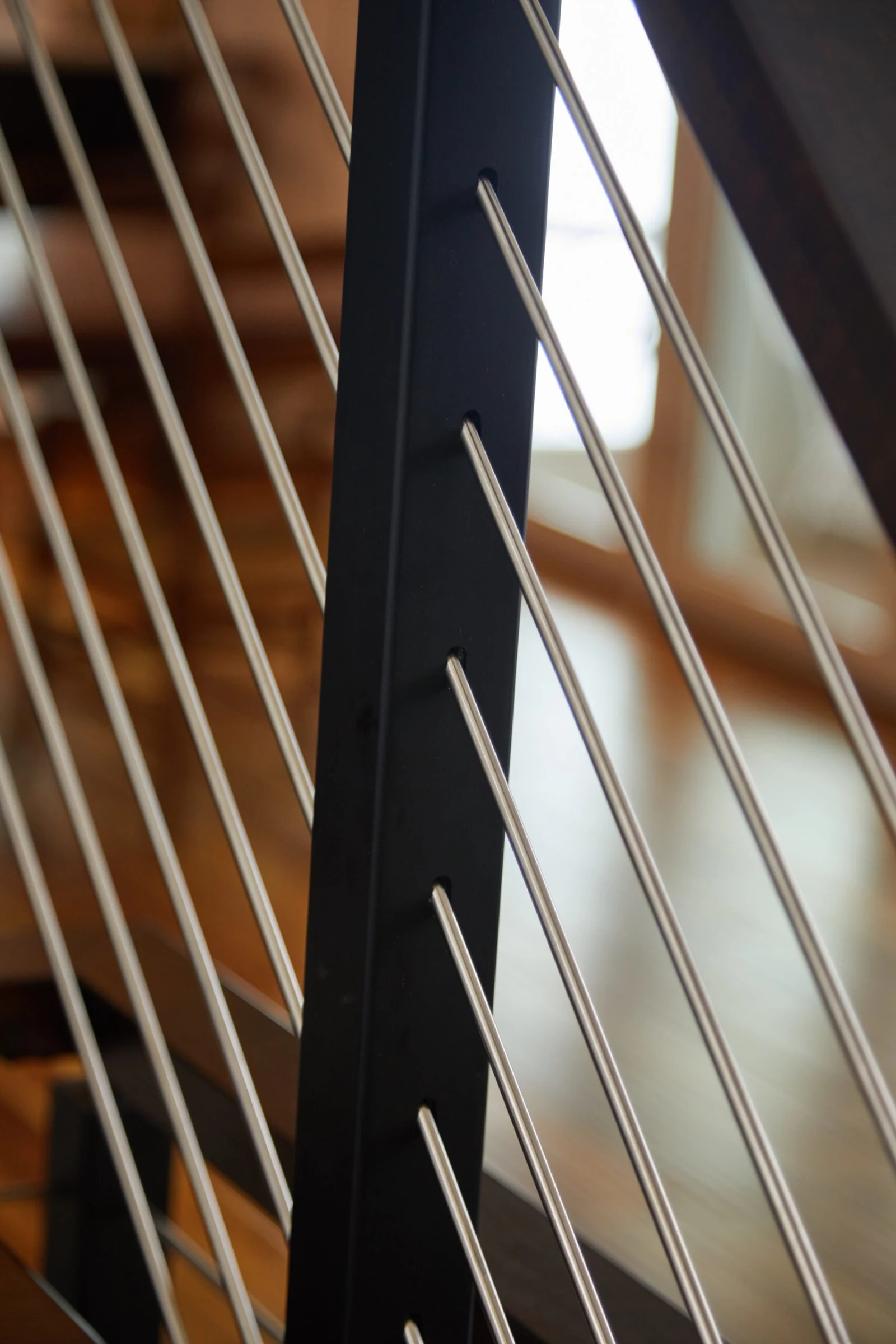 Tight shot of rod ends anchored in a black powder-coated post