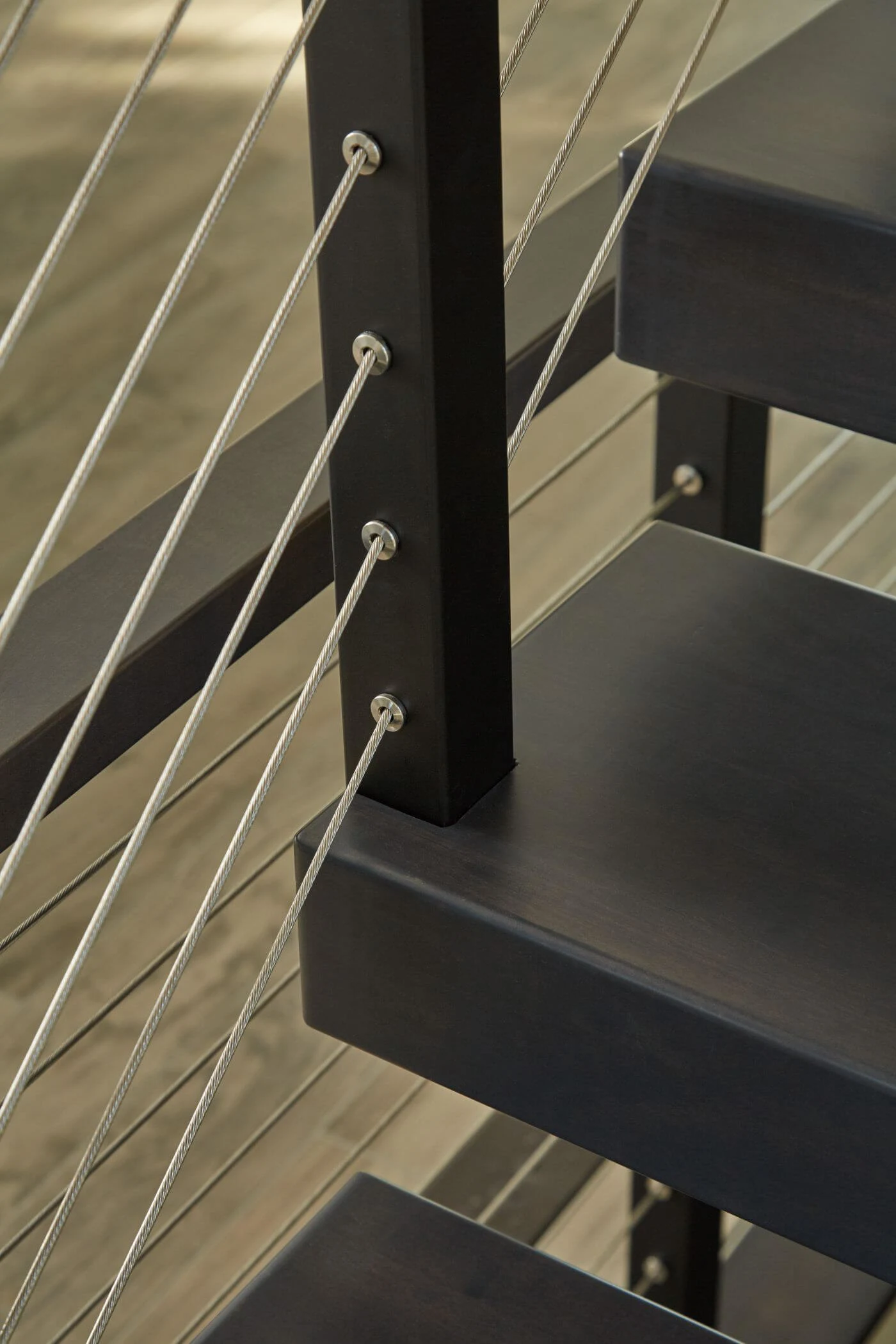 Post mounted into the inner edge of a dark tread above decking