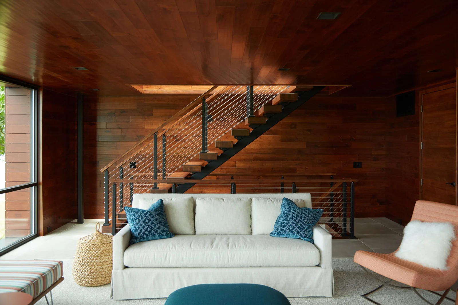 Sofa beneath the flight with the cable railing overlook behind