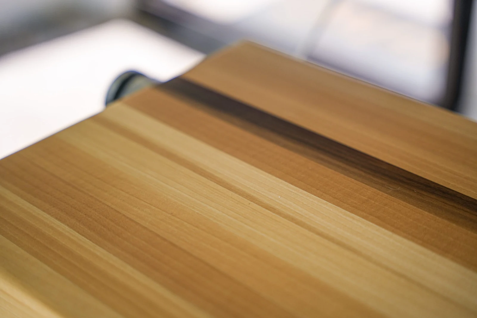 Tight crop on the striped grain running across a clear-finished tread surface