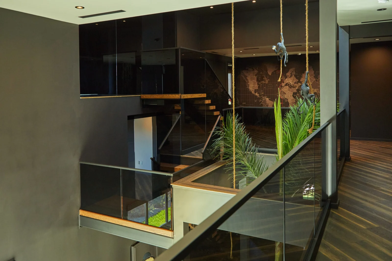 Tinted glass balcony run above the planted bed and wide-plank floor